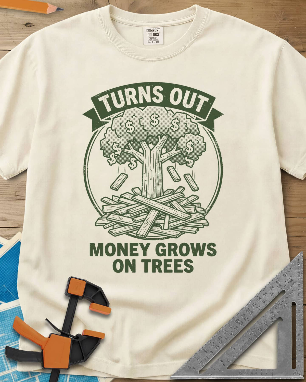 Money Grows On Trees heavyweight tee in Ivory, a round emblem of a tree with dollar-sign leaves above a lumber pile