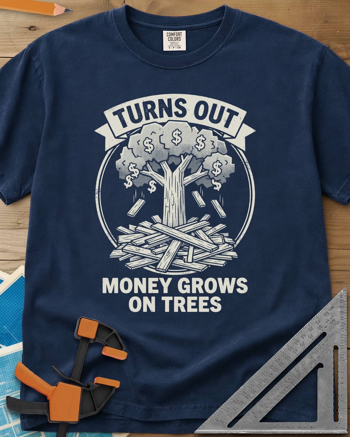 Money Grows On Trees heavyweight tee in Navy, a round emblem of a tree with dollar-sign leaves above a lumber pile