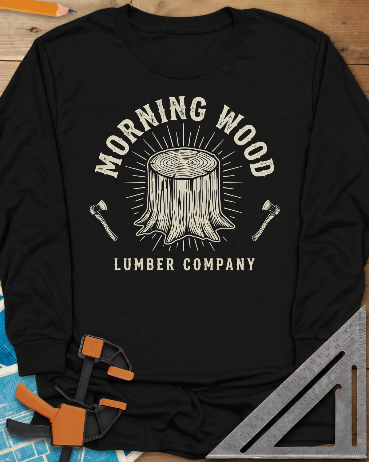 Morning Wood Lumber Company long sleeve shirt in Black, a tree stump with sunburst rays between two axes