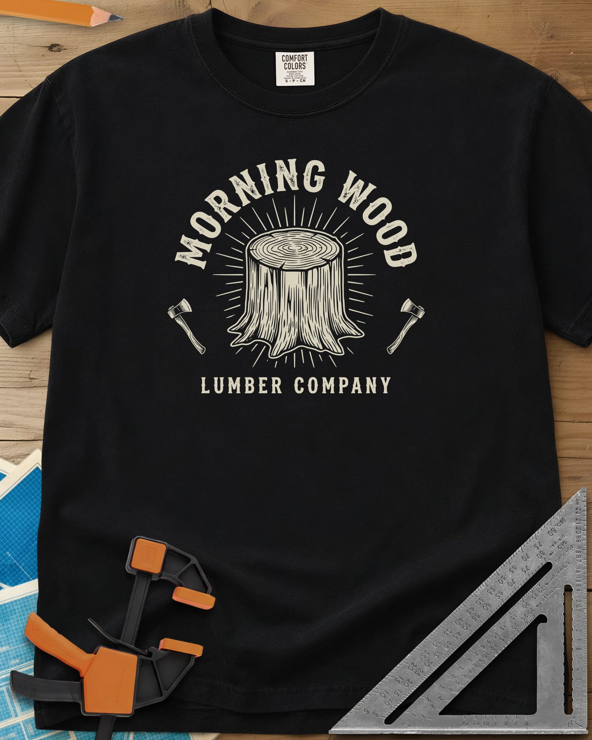 Morning Wood Lumber Company heavyweight tee in Black, a tree stump with sunburst rays between two axes