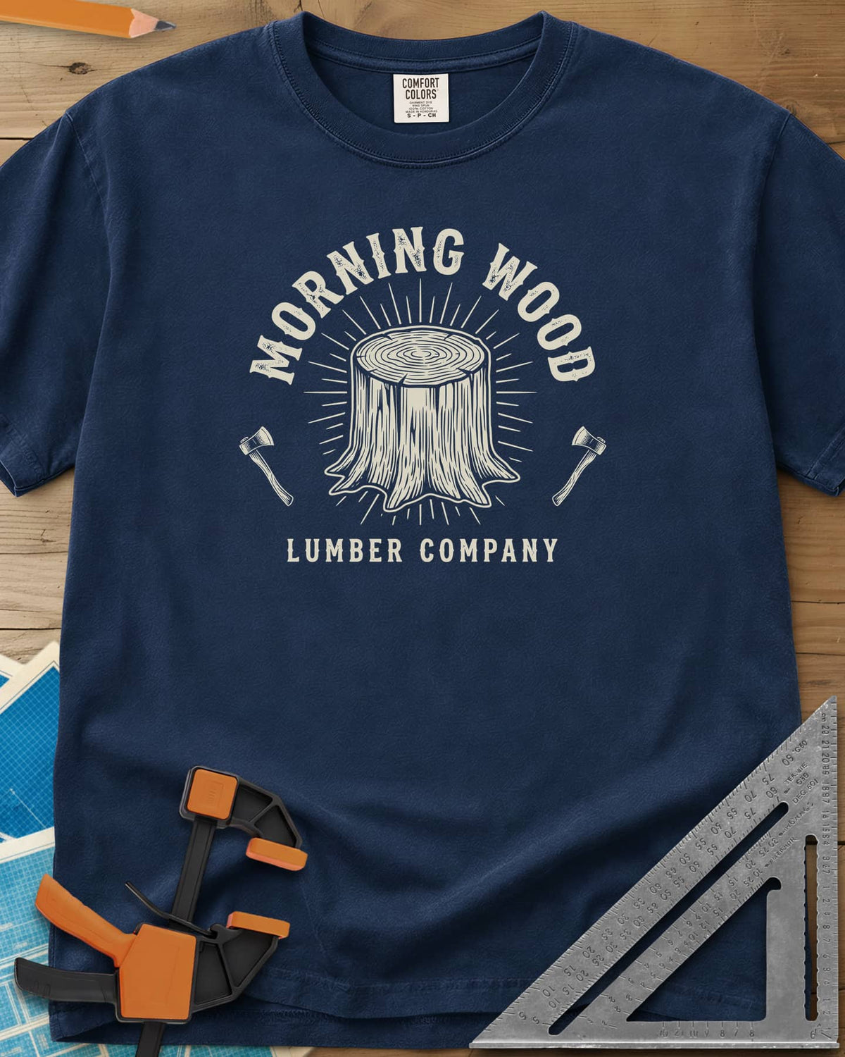 Morning Wood Lumber Company heavyweight tee in Navy, a tree stump with sunburst rays between two axes