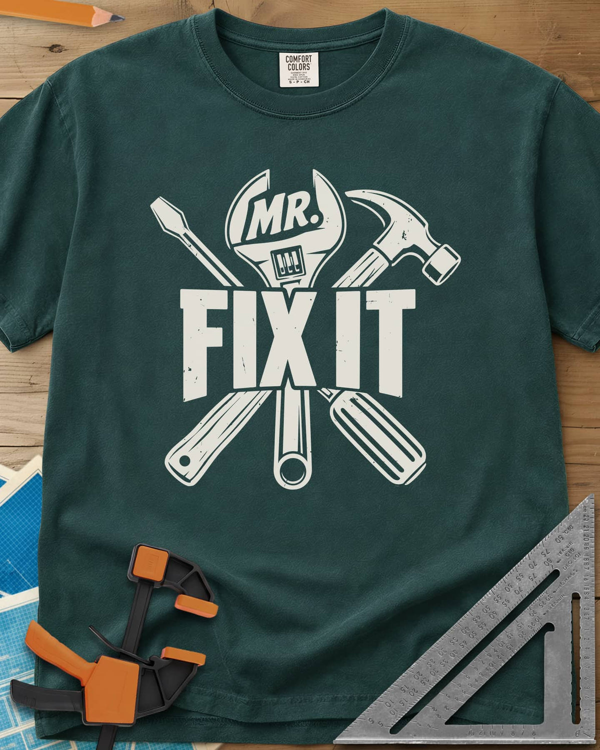 Mr. Fix It heavyweight tee in Blue Spruce, crossed wrench, hammer and screwdriver behind block letters