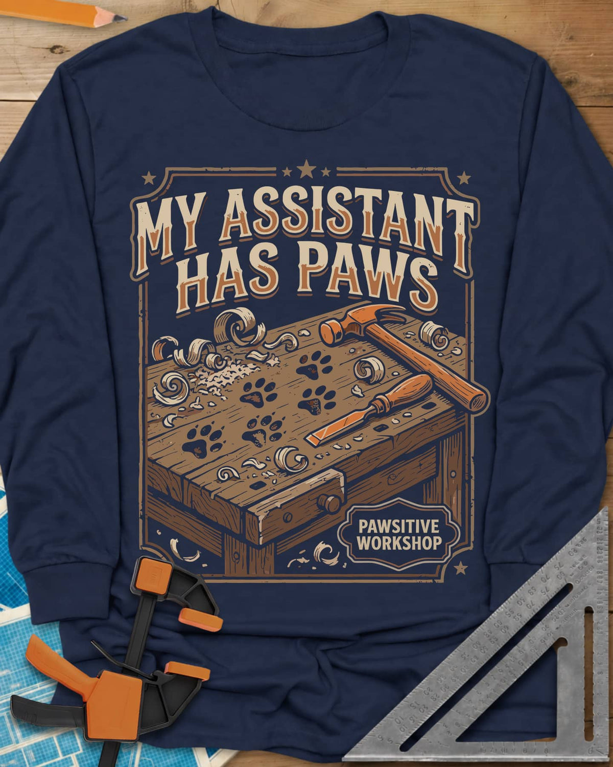 My Assistant Has Paws long sleeve shirt in Navy, workbench with paw prints, shavings, a hammer and a chisel