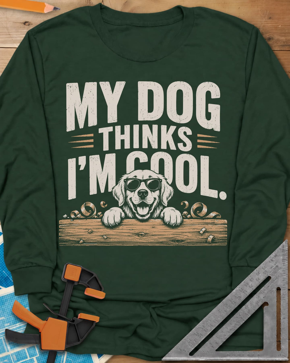 My Dog Thinks I’m Cool long sleeve shirt in Forest Green, a golden retriever in sunglasses peeking over a wood plank
