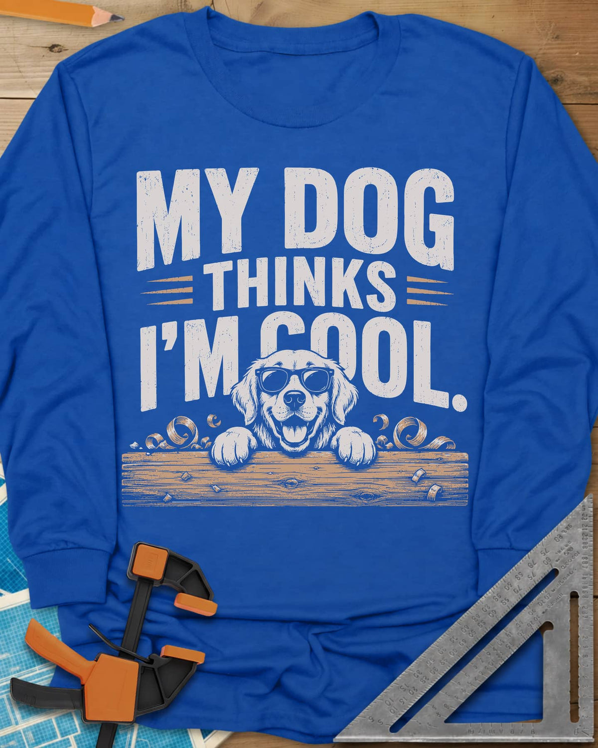My Dog Thinks I’m Cool long sleeve shirt in Royal, a golden retriever in sunglasses peeking over a wood plank