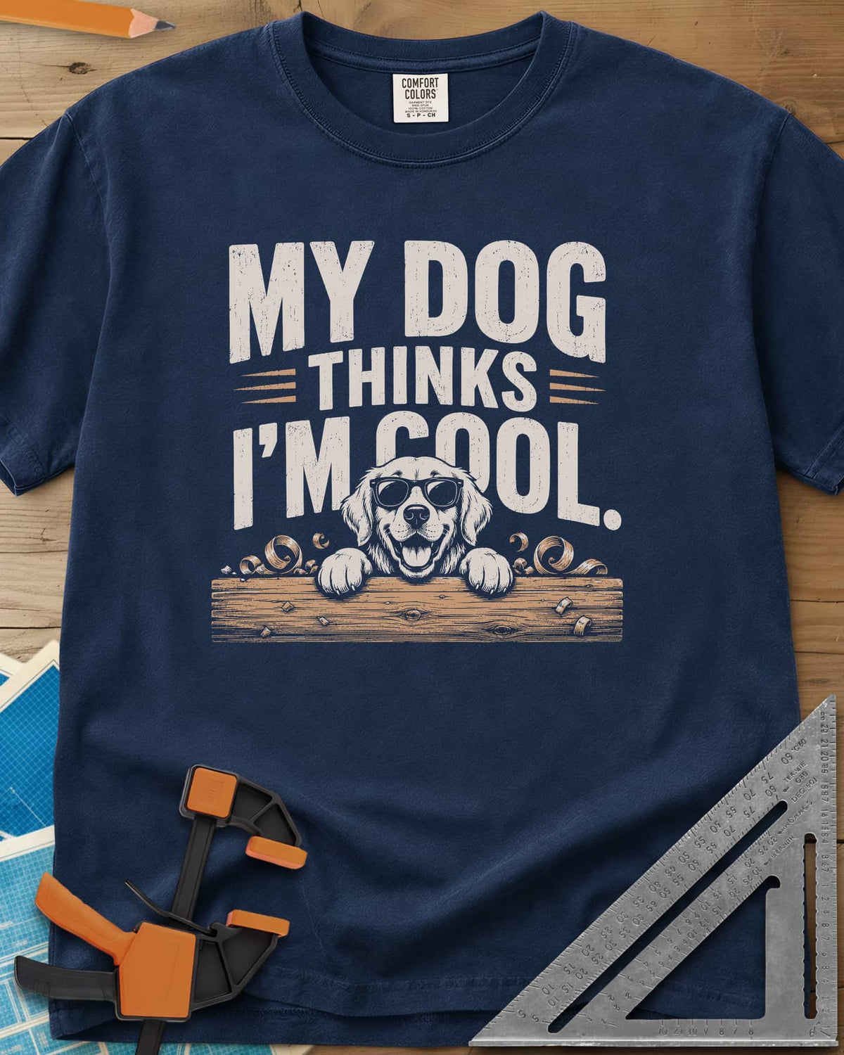 My Dog Thinks I’m Cool heavyweight tee in Navy, a golden retriever in sunglasses peeking over a wood plank