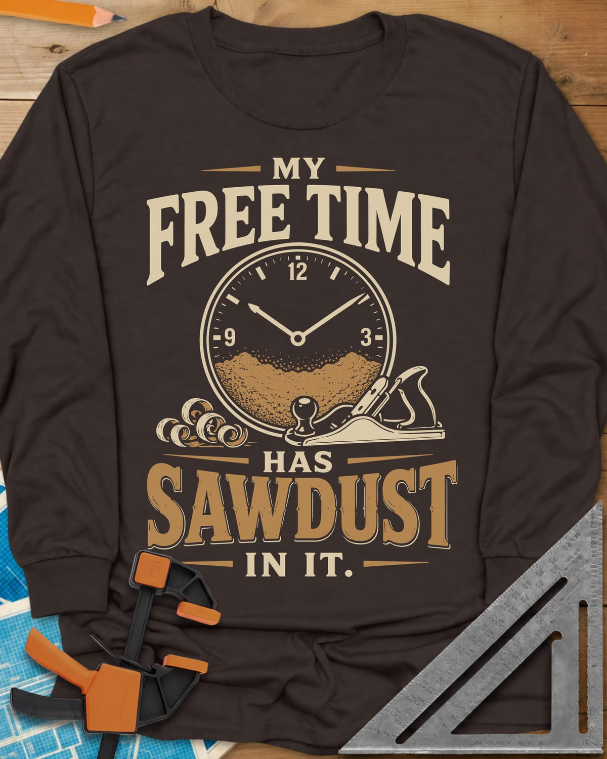 My Free Time Has Sawdust In It long sleeve shirt in Dark Chocolate, a clock face half full of sawdust beside a hand plane