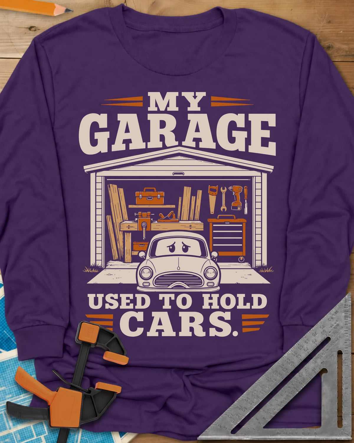 My Garage Used To Hold Cars long sleeve shirt in Purple, an open garage full of lumber and tools with a worried car