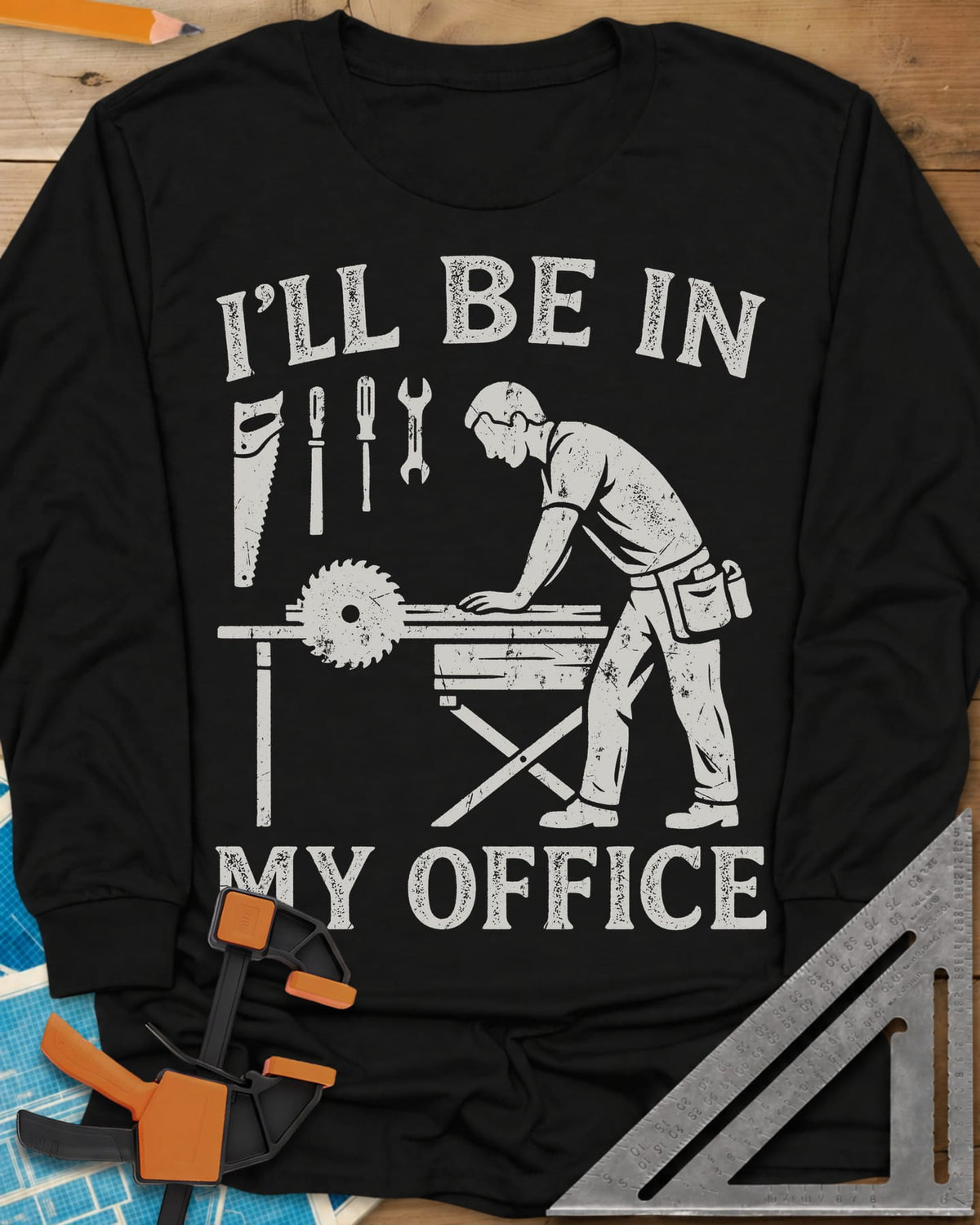 My Office long sleeve shirt in Black, a woodworker at a table saw with hand tools hung above