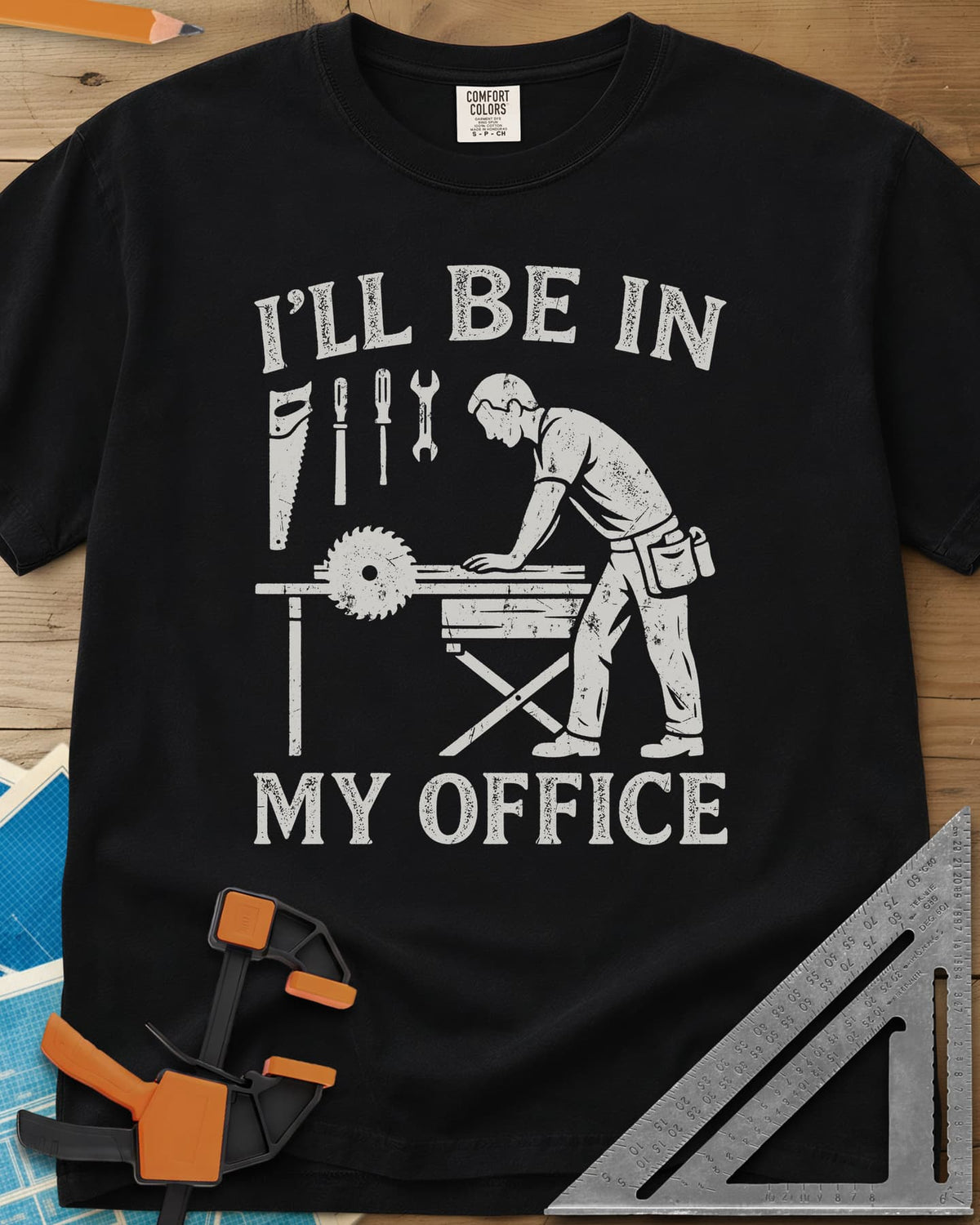 My Office heavyweight tee in Black, a woodworker at a table saw with hand tools hung above