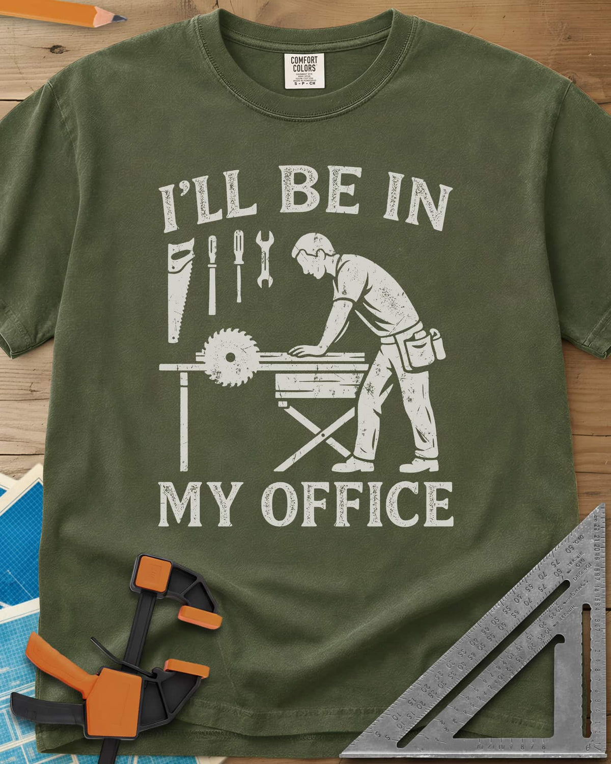 My Office heavyweight tee in Hemp, a woodworker at a table saw with hand tools hung above