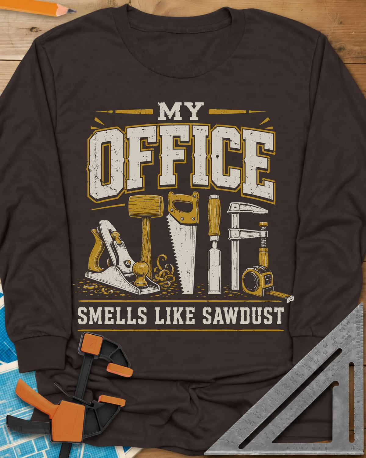 My Office Smells Like Sawdust long sleeve shirt in Dark Chocolate, a row of hand tools: plane, mallet, saw, chisel, clamp