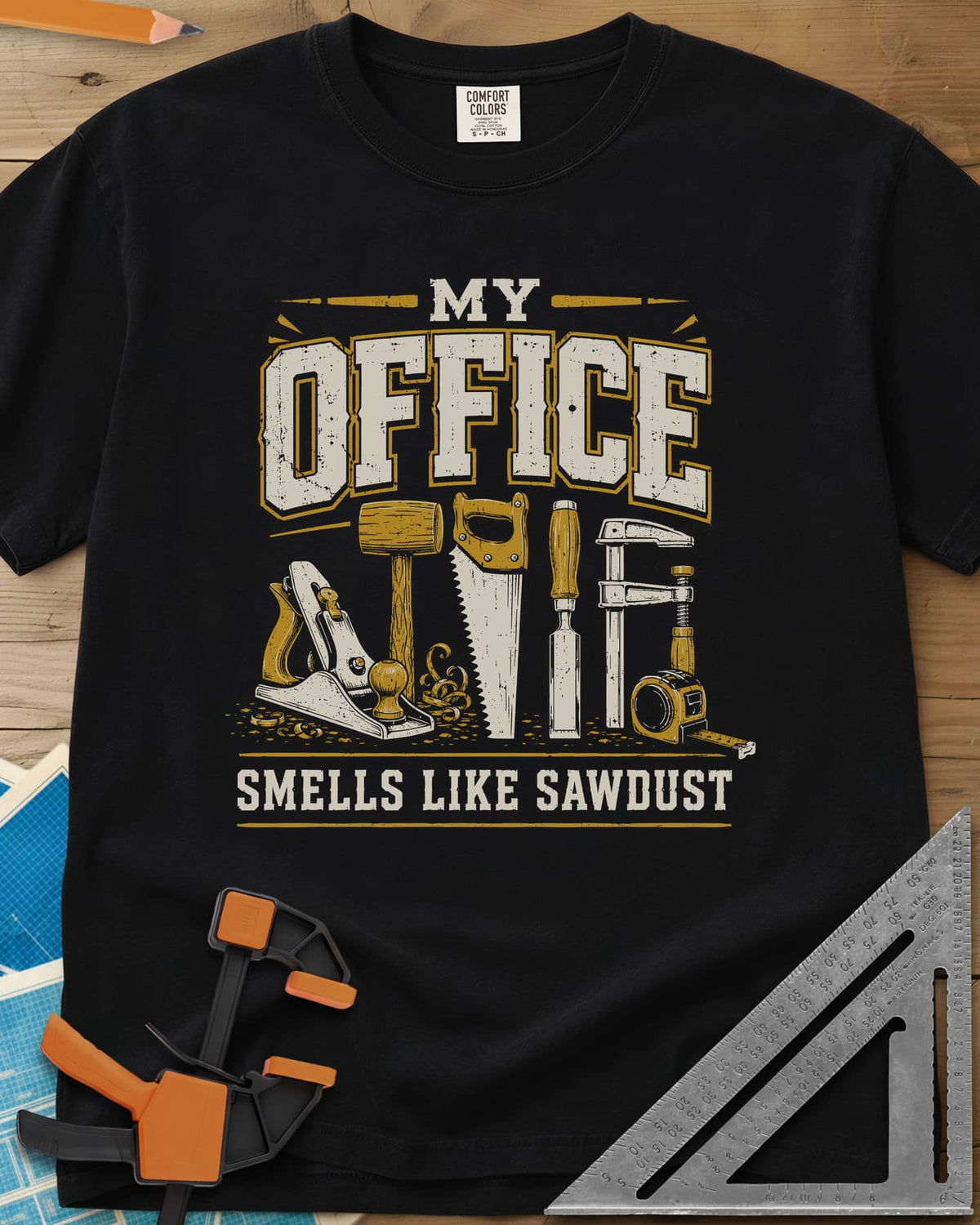 My Office Smells Like Sawdust heavyweight tee in Black, a row of hand tools: plane, mallet, saw, chisel, clamp, tape