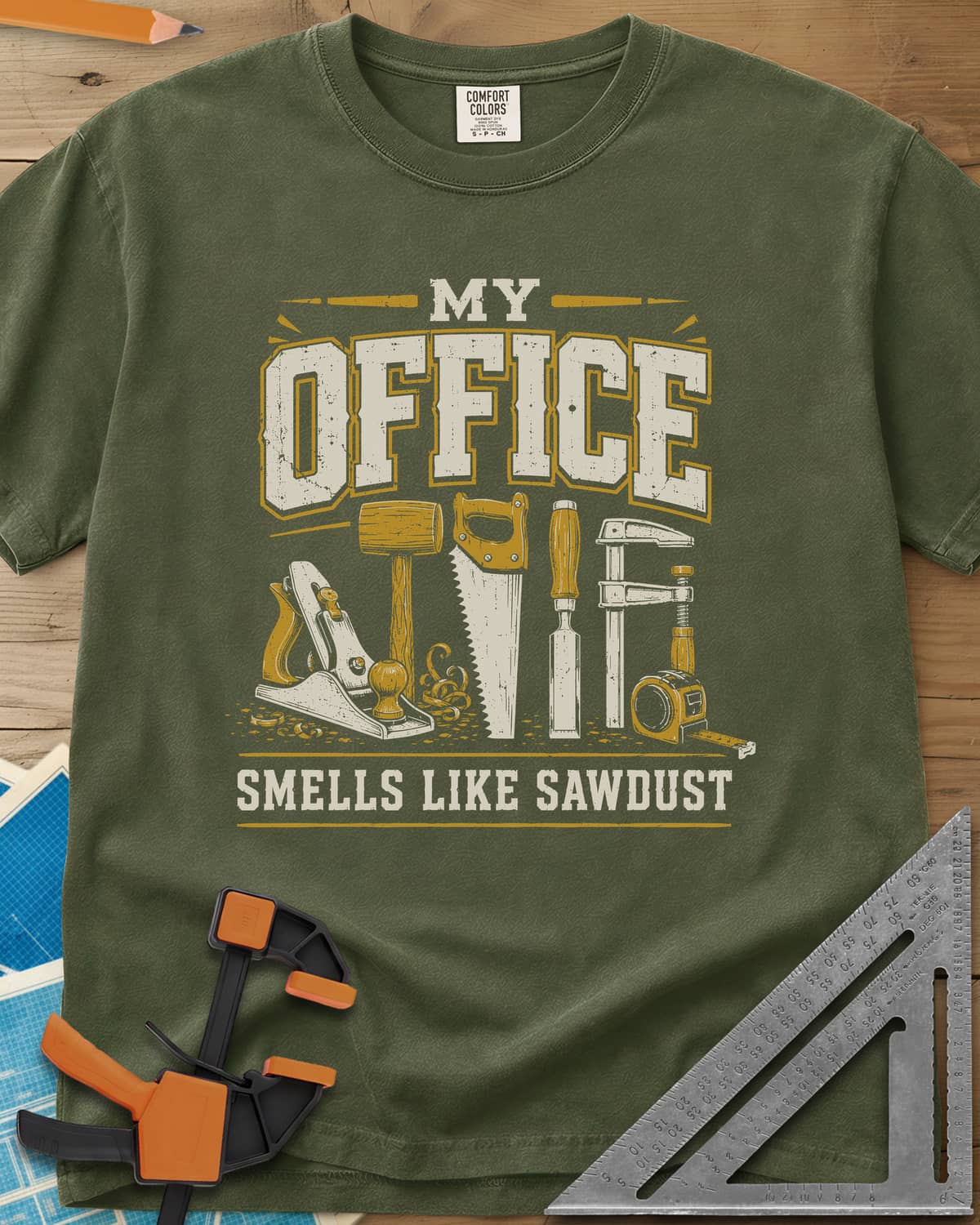 My Office Smells Like Sawdust heavyweight tee in Hemp, a row of hand tools: plane, mallet, saw, chisel, clamp, tape