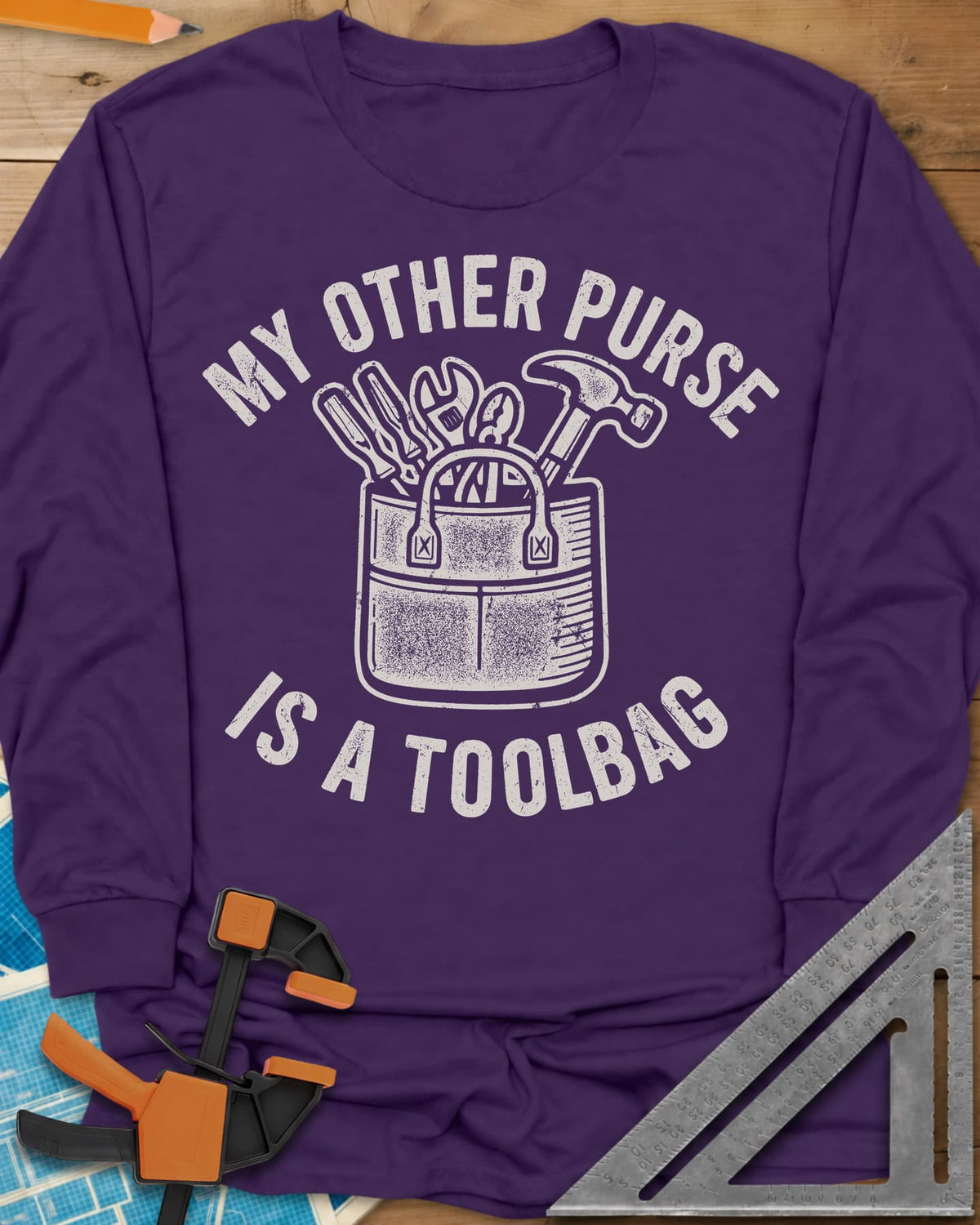 My Other Purse long sleeve shirt in Purple, a tool bag with a hammer, wrench, pliers and screwdrivers