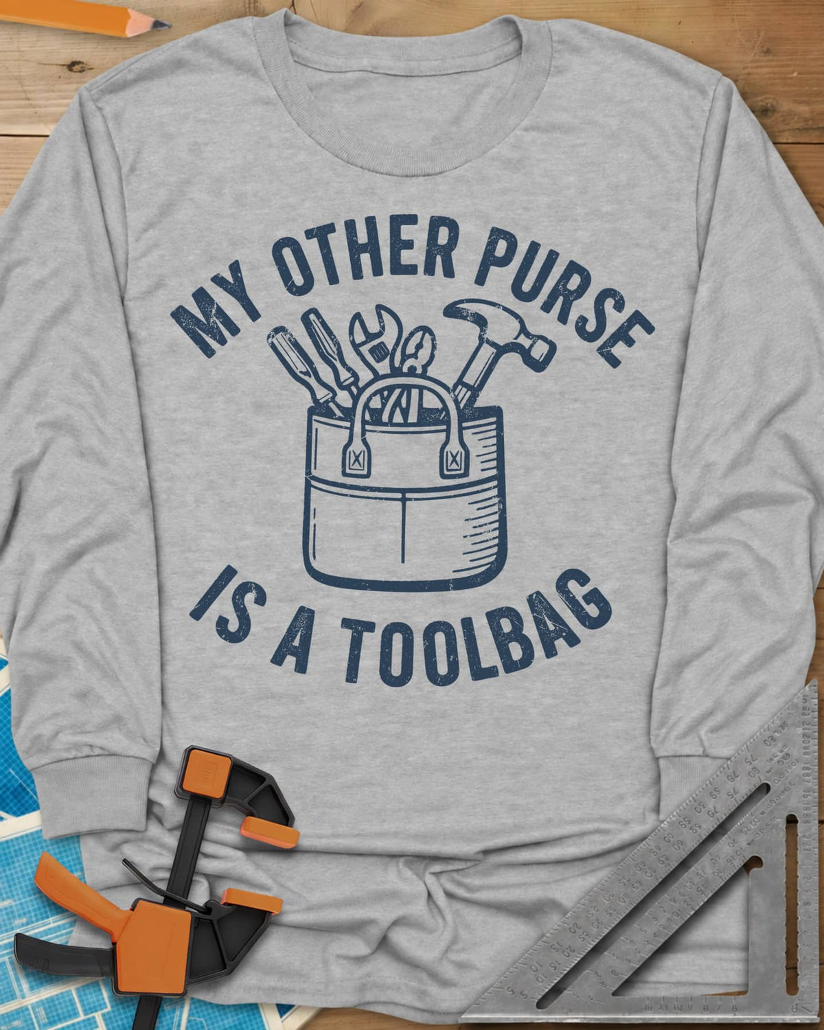 My Other Purse long sleeve shirt in Sport Grey, a tool bag with a hammer, wrench, pliers and screwdrivers