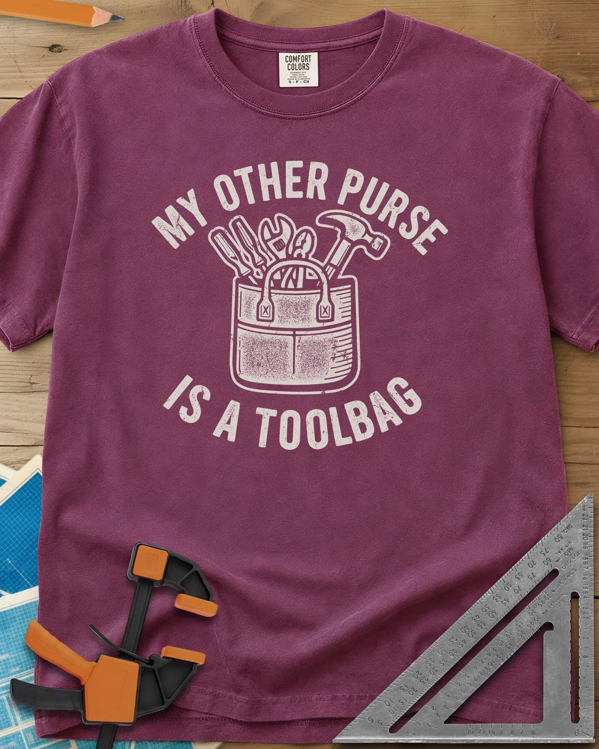 My Other Purse heavyweight tee in Berry, a tool bag with a hammer, wrench, pliers and screwdrivers