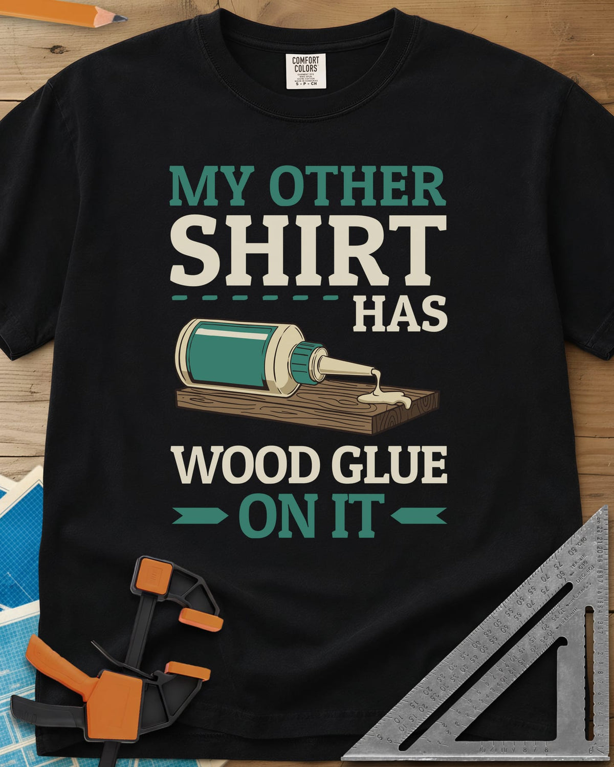 My Other Shirt Has Wood Glue On It heavyweight tee in Black, a tipped-over wood glue bottle dripping onto a board