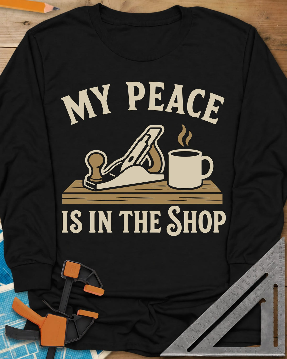 My Peace Is In The Shop long sleeve shirt in Black, a hand plane on a plank beside a steaming coffee mug