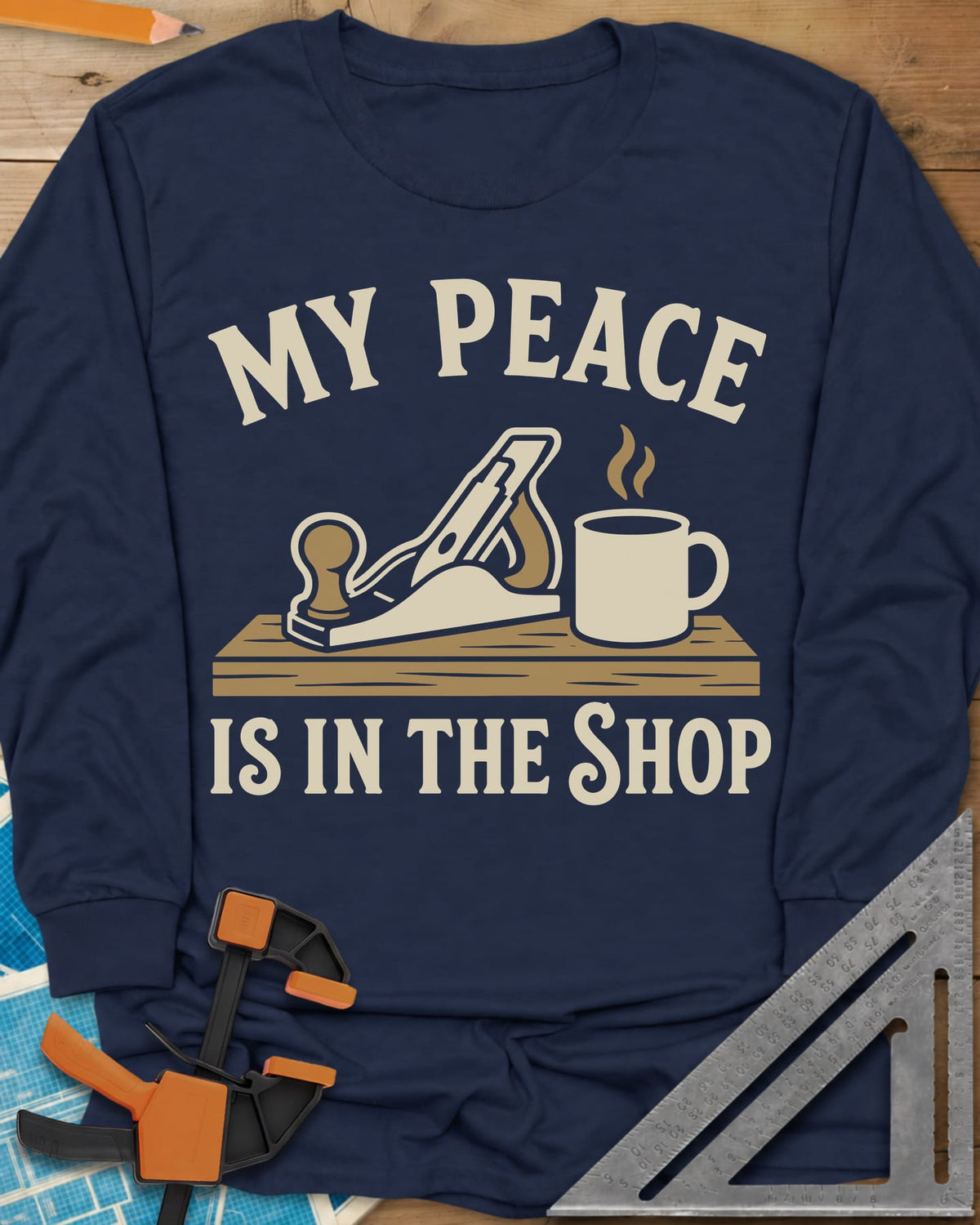 My Peace Is In The Shop long sleeve shirt in Navy, a hand plane on a plank beside a steaming coffee mug