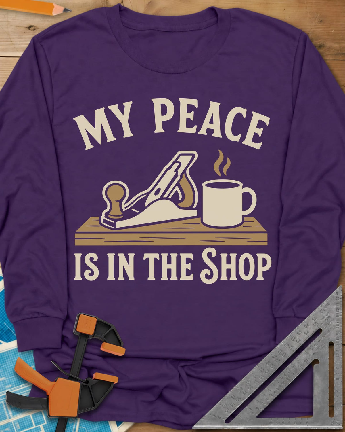 My Peace Is In The Shop long sleeve shirt in Purple, a hand plane on a plank beside a steaming coffee mug