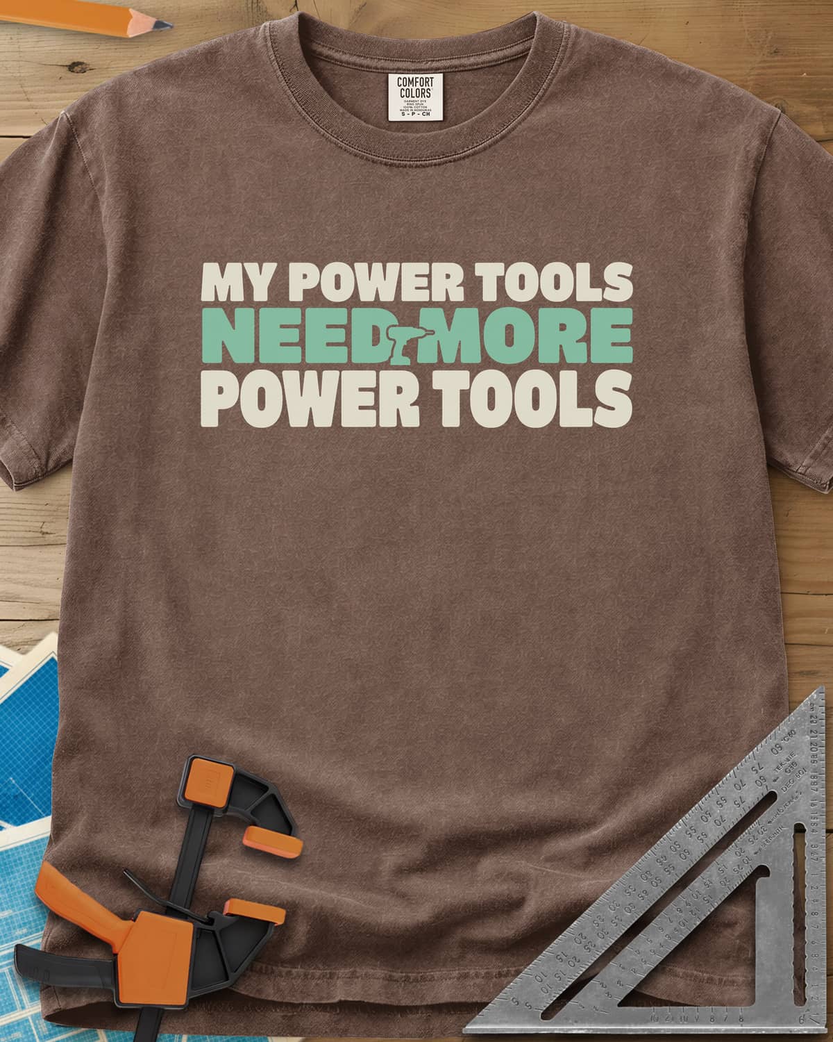 My Power Tools Need More Power Tools heavyweight tee in Espresso, bold three-line type with a tiny cordless drill in the