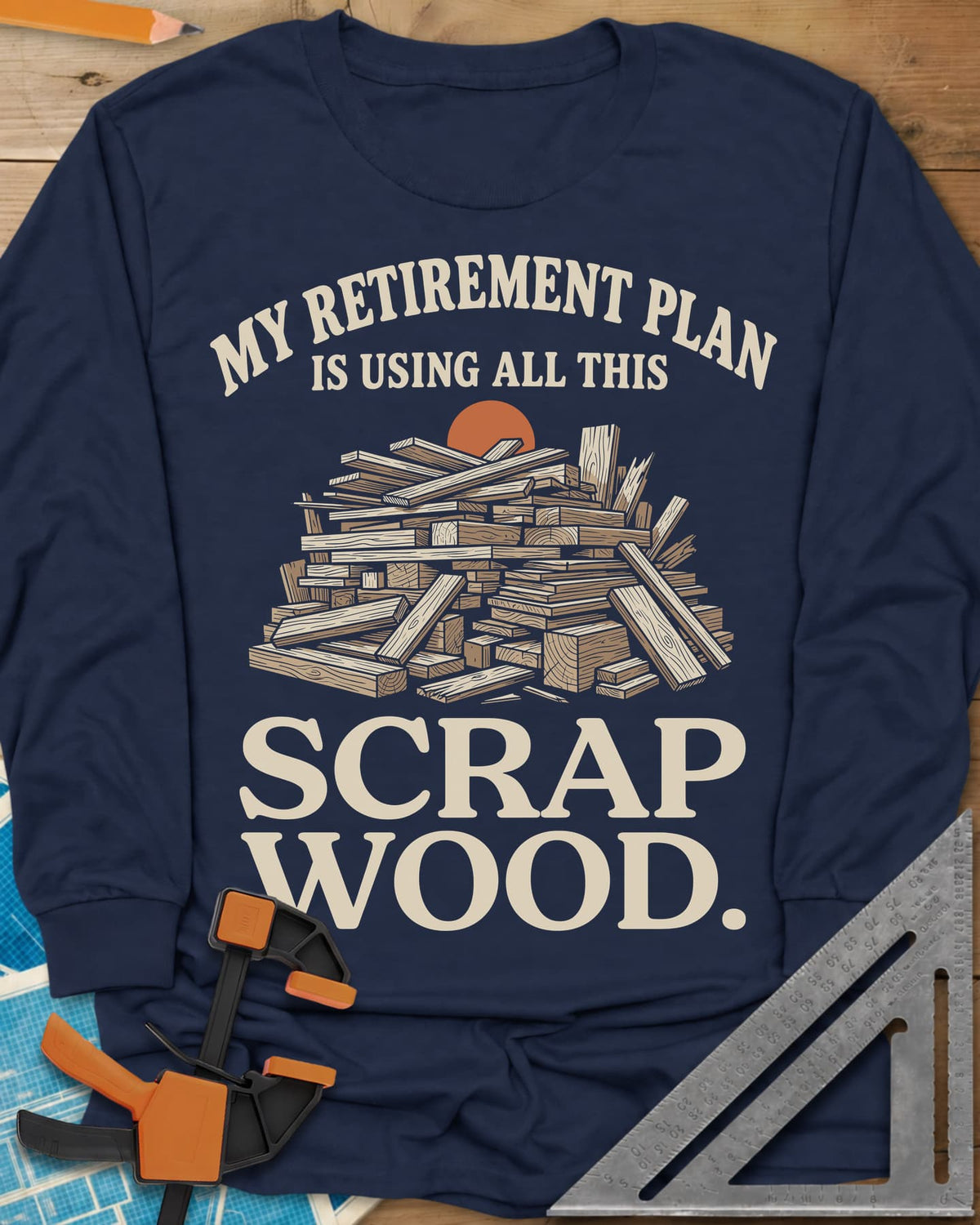 My Retirement Plan Scrap Wood long sleeve shirt in Navy, a heaped pile of scrap boards in front of a setting sun