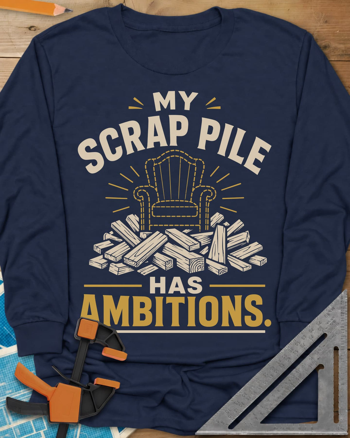 My Scrap Pile Has Ambitions long sleeve shirt in Navy, a dotted gold armchair outline rising from a pile of wood offcuts