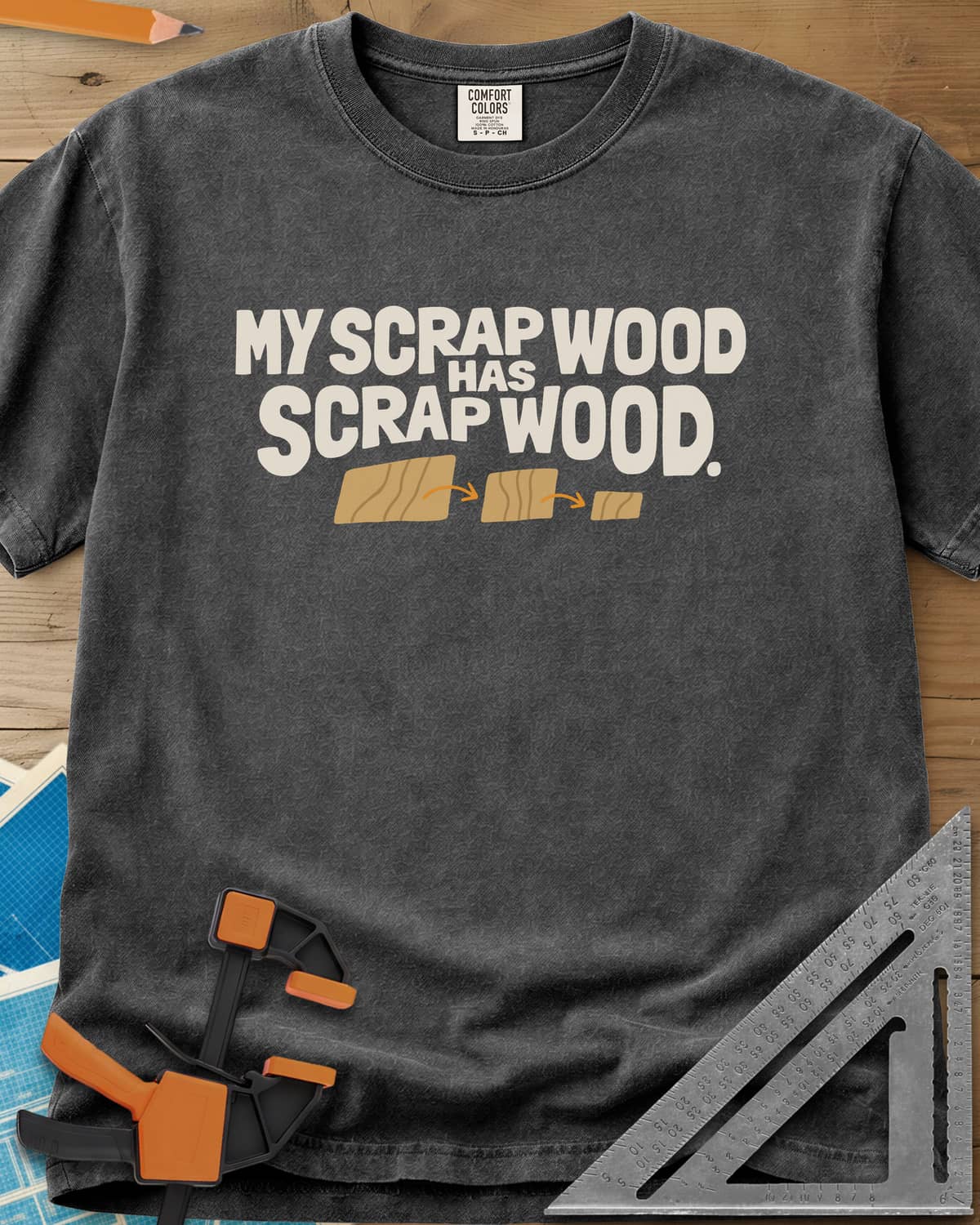 My Scrap Wood Has Scrap Wood heavyweight tee in Pepper, three wood pieces getting smaller, linked by orange arrows
