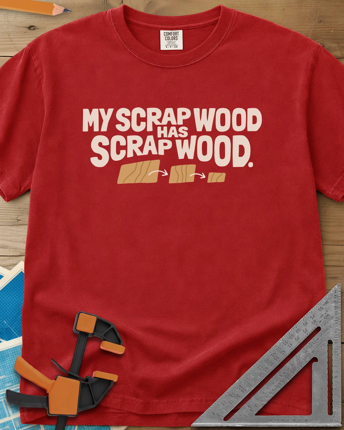My Scrap Wood Has Scrap Wood heavyweight tee in Red, three wood pieces getting smaller, linked by orange arrows