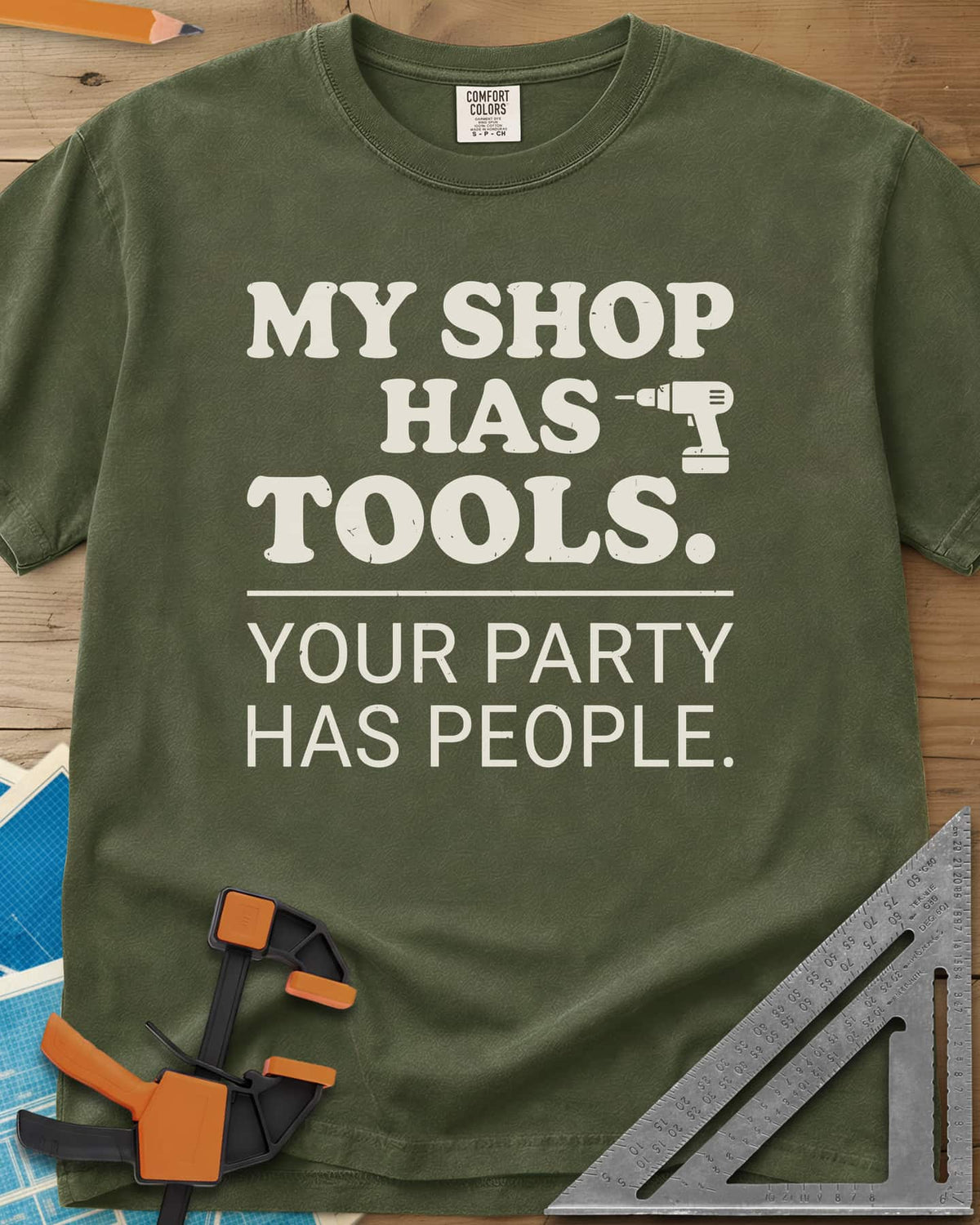 My Shop Has Tools Your Party Has People heavyweight tee in Hemp, two-part slogan split by a line, with a small cordless