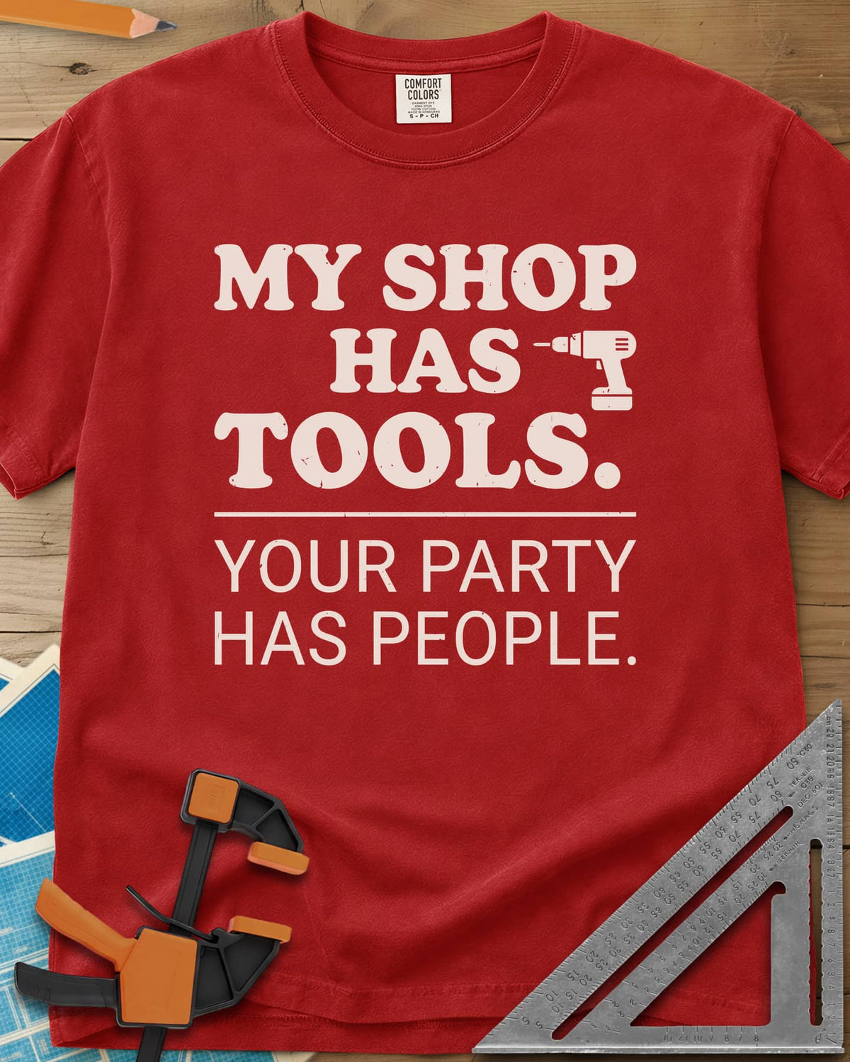 My Shop Has Tools Your Party Has People heavyweight tee in Red, two-part slogan split by a line, with a small cordless drill