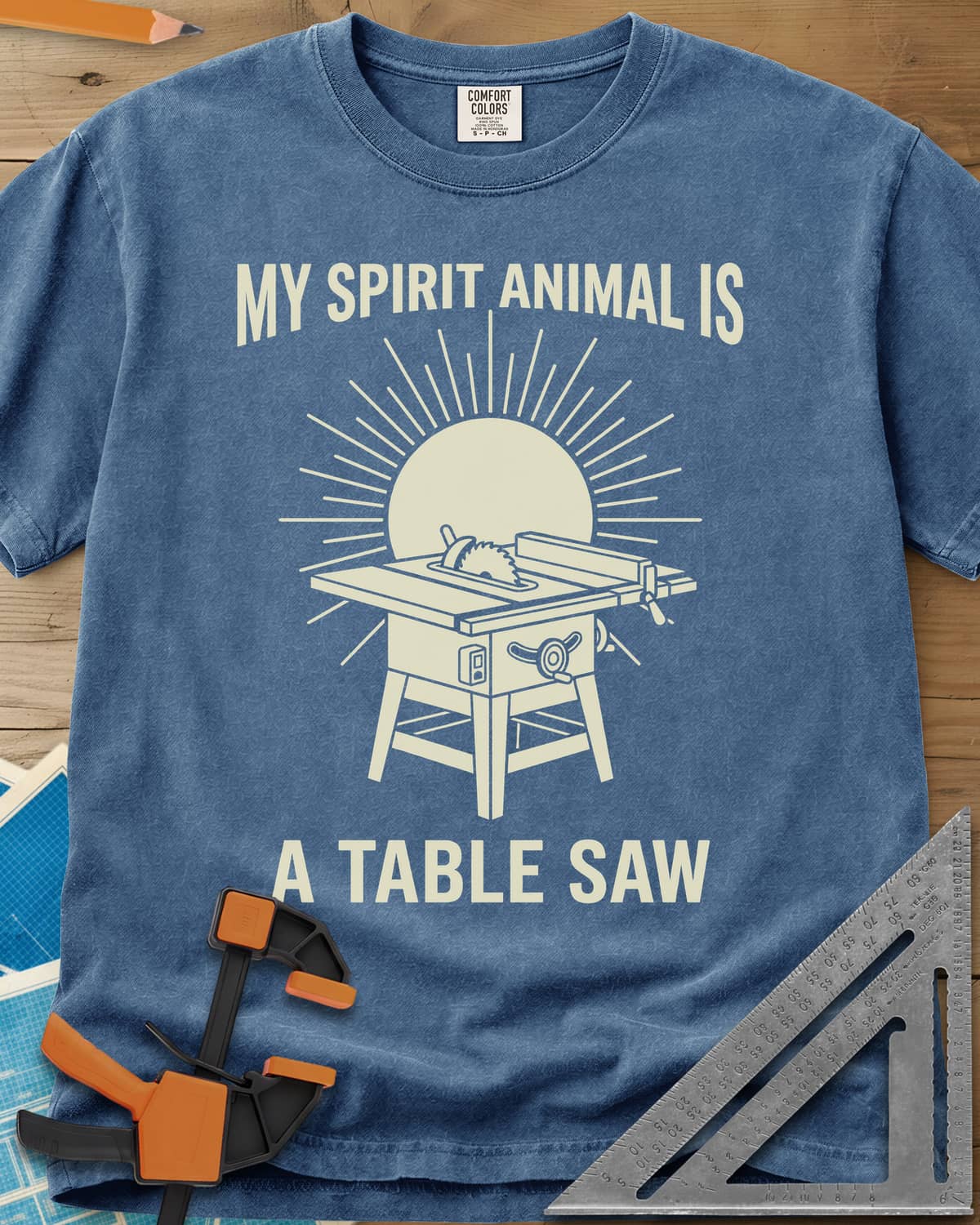 My Spirit Animal Is A Table Saw heavyweight tee in Blue Jean, a table saw drawn in front of a sunburst