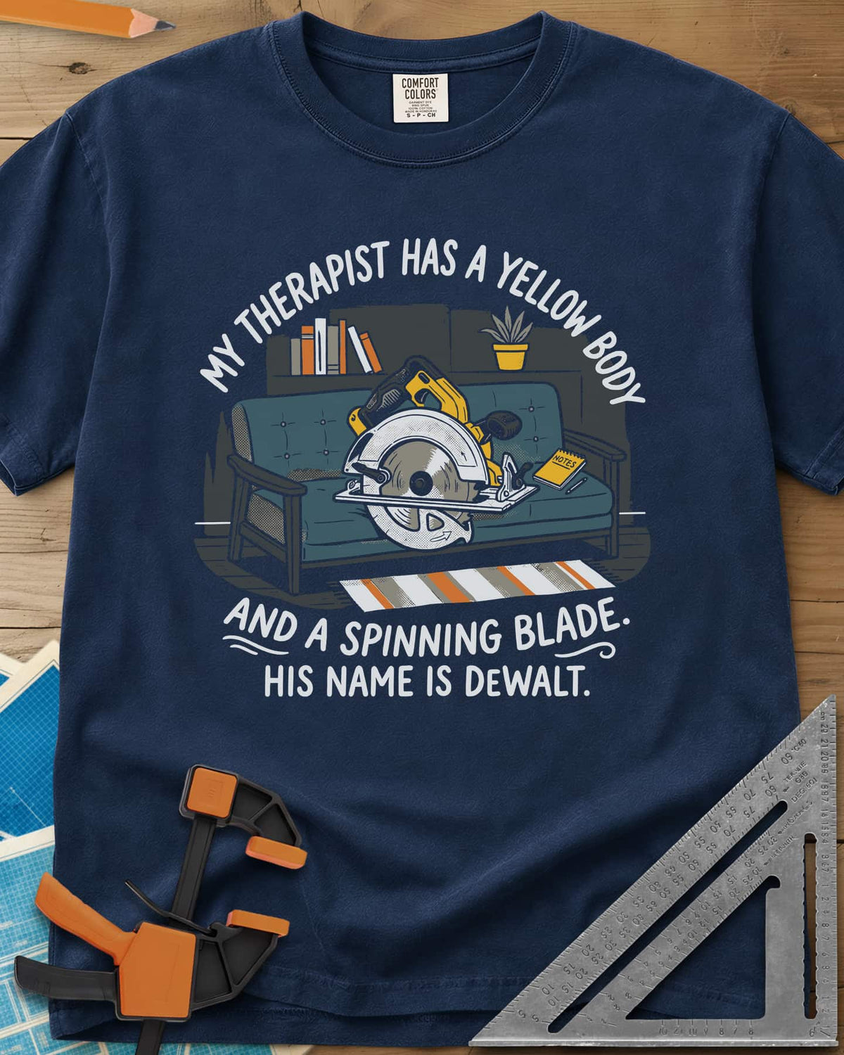 My Therapist Has A Spinning Blade heavyweight tee in Navy, a cartoon yellow circular saw lounging on a teal couch