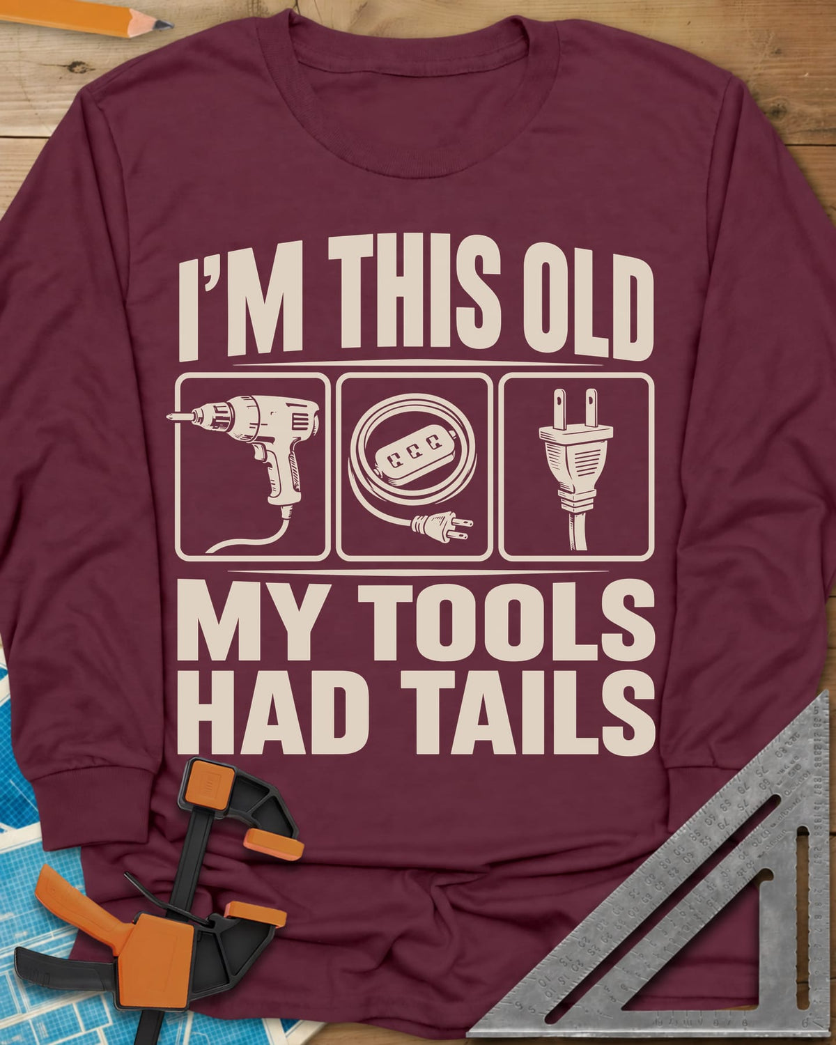 My Tools Had Tails long sleeve shirt in Maroon, three framed panels: a corded drill, an extension cord, a plug