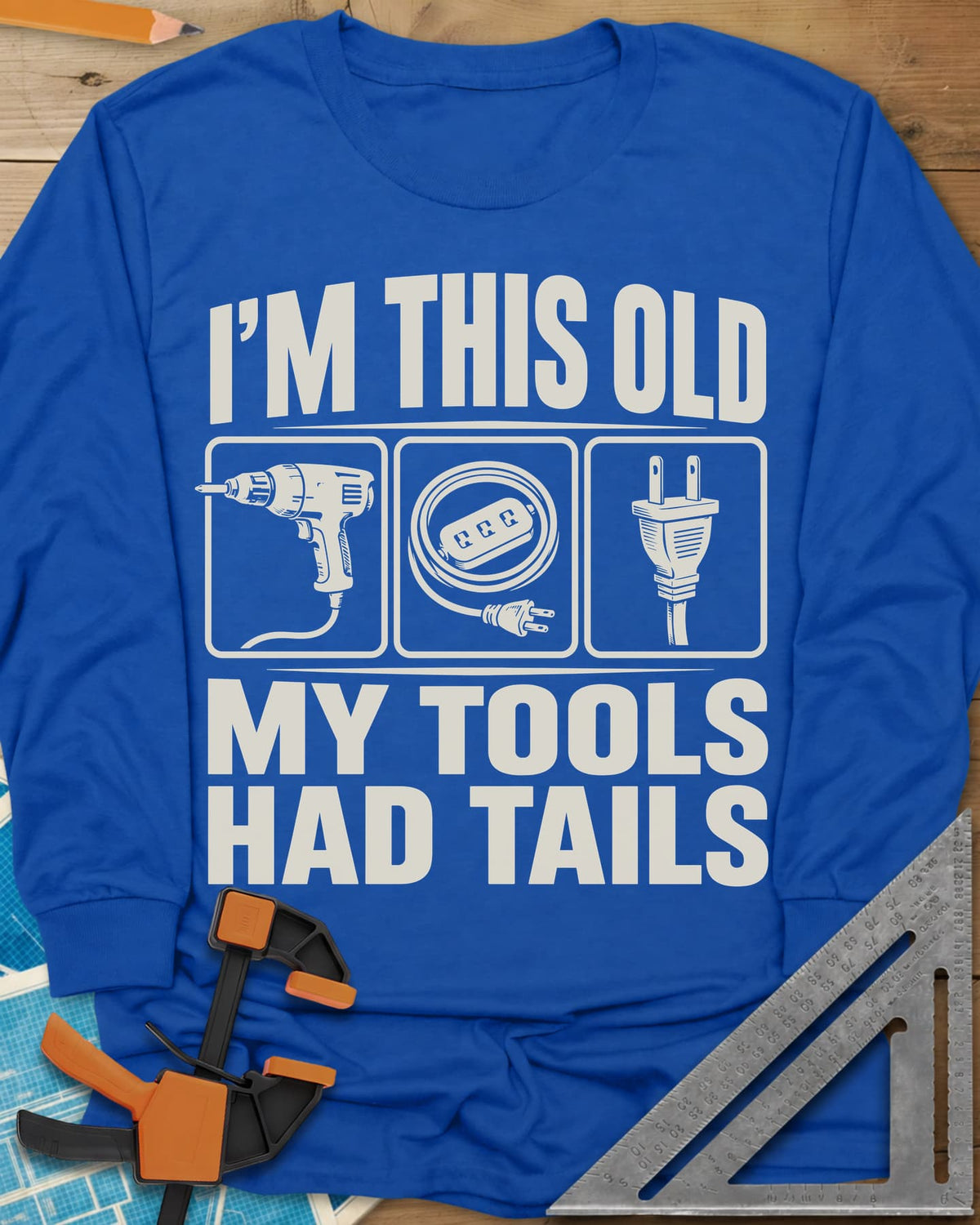 My Tools Had Tails long sleeve shirt in Royal, three framed panels: a corded drill, an extension cord, a plug