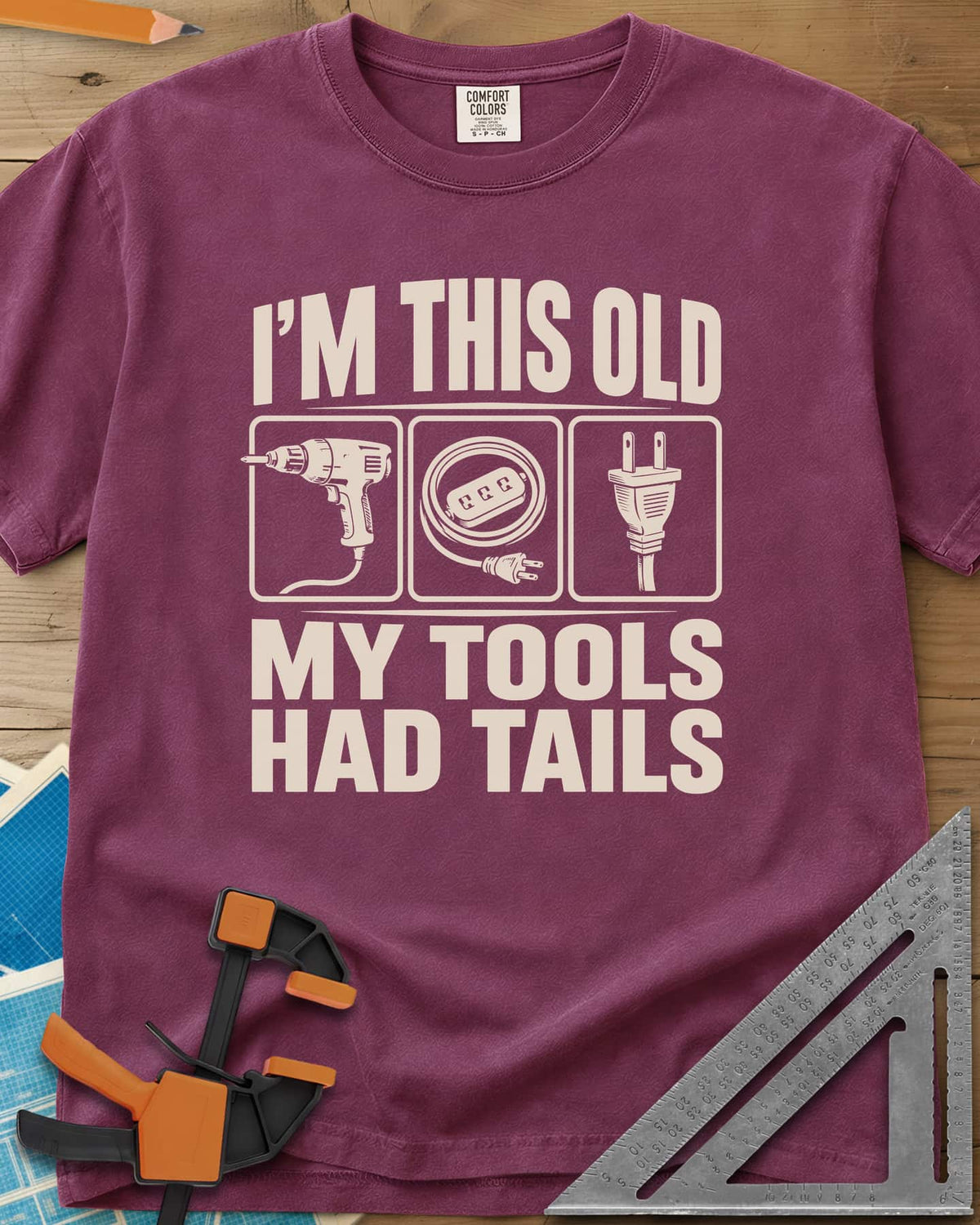 My Tools Had Tails heavyweight tee in Berry, three framed panels: a corded drill, an extension cord, a plug