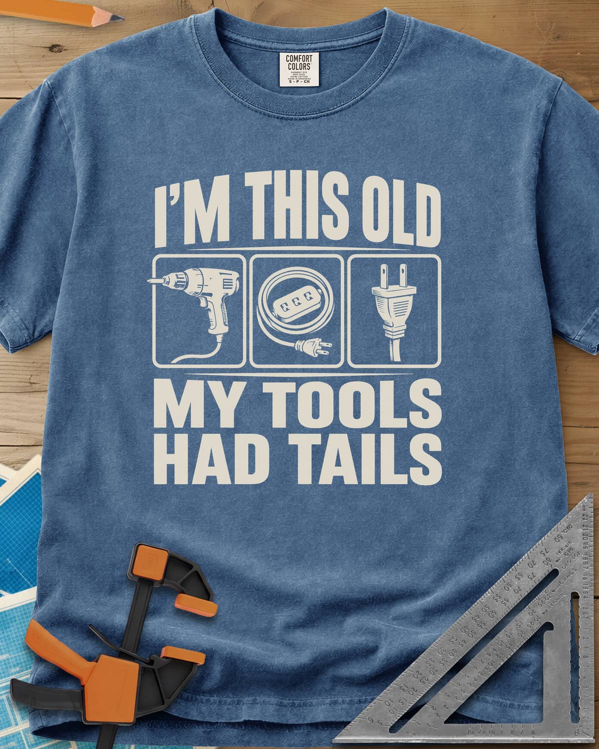 My Tools Had Tails heavyweight tee in Blue Jean, three framed panels: a corded drill, an extension cord, a plug