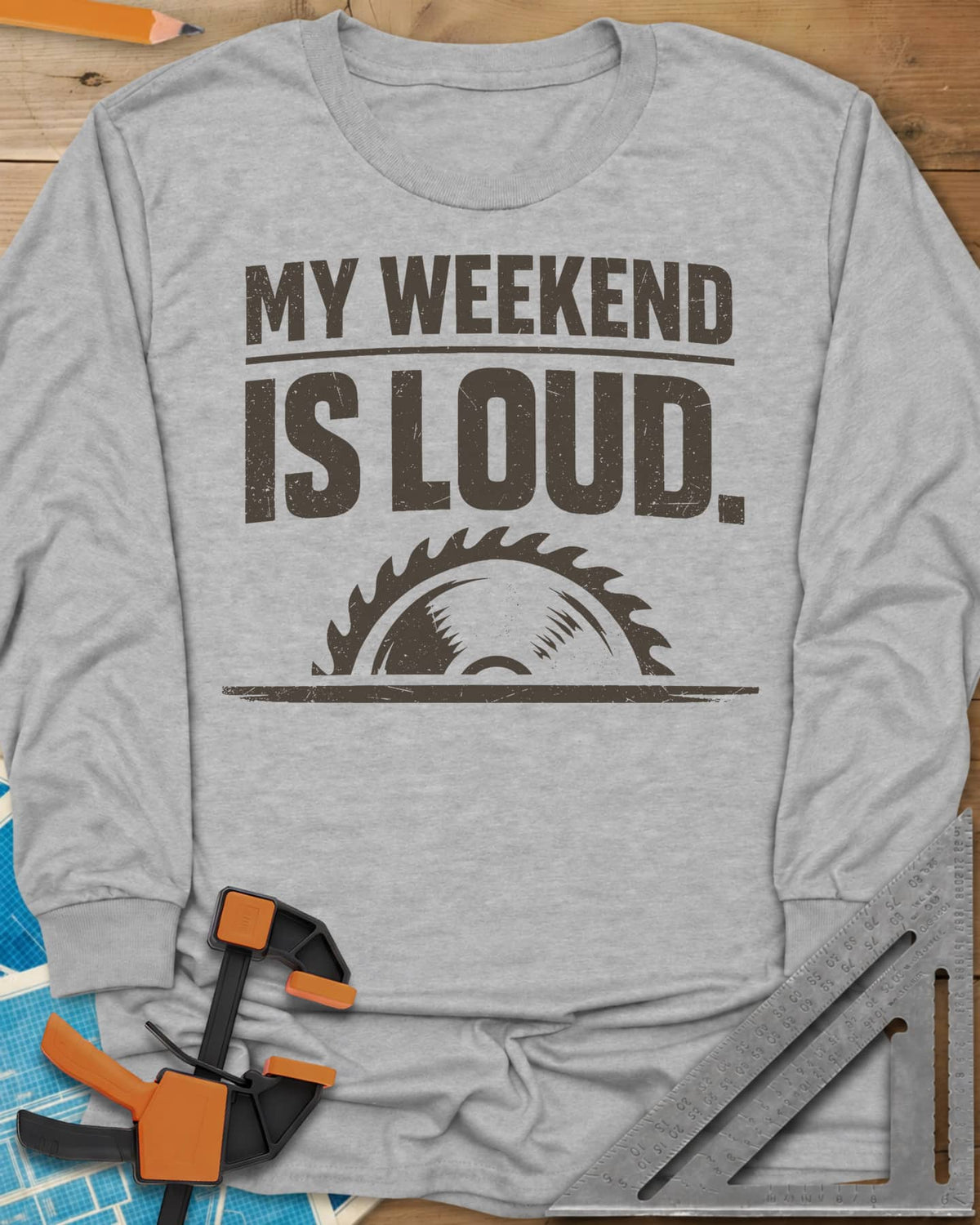 My Weekend Is Loud long sleeve shirt in Sport Grey, distressed block lettering over half a saw blade rising from a line