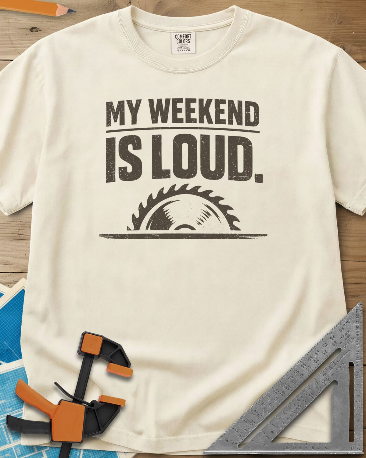 My Weekend Is Loud heavyweight tee in Ivory, distressed block lettering over half a saw blade rising from a line