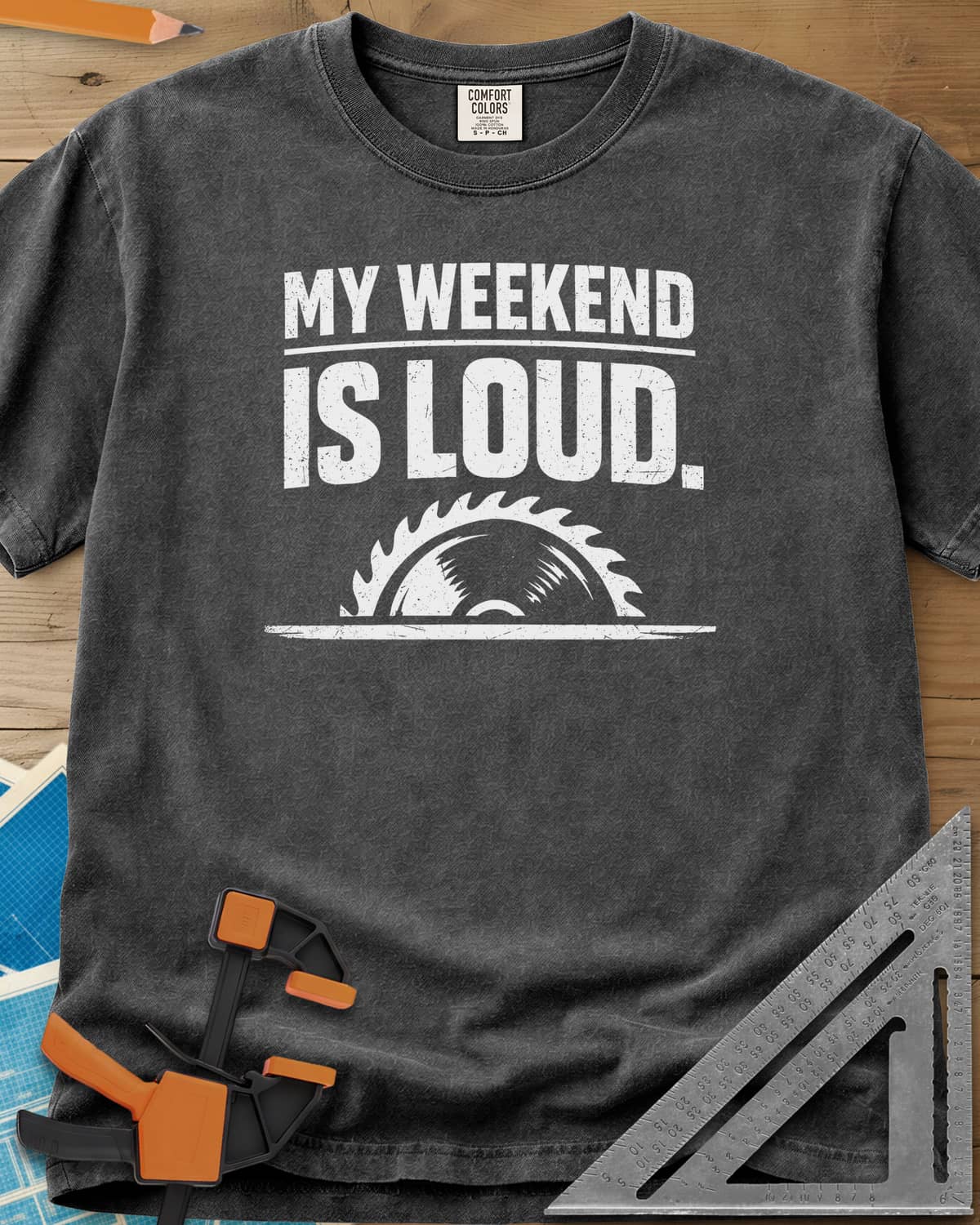 My Weekend Is Loud heavyweight tee in Pepper, distressed block lettering over half a saw blade rising from a line