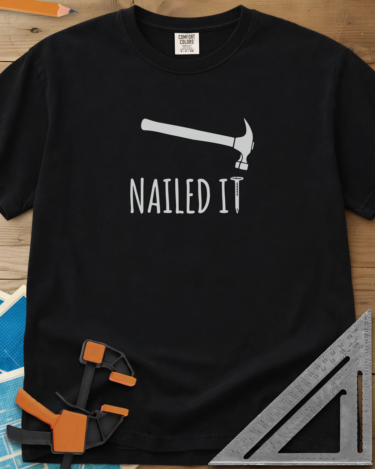 Nailed It heavyweight tee in Black, a hammer over a nail that forms the T in IT