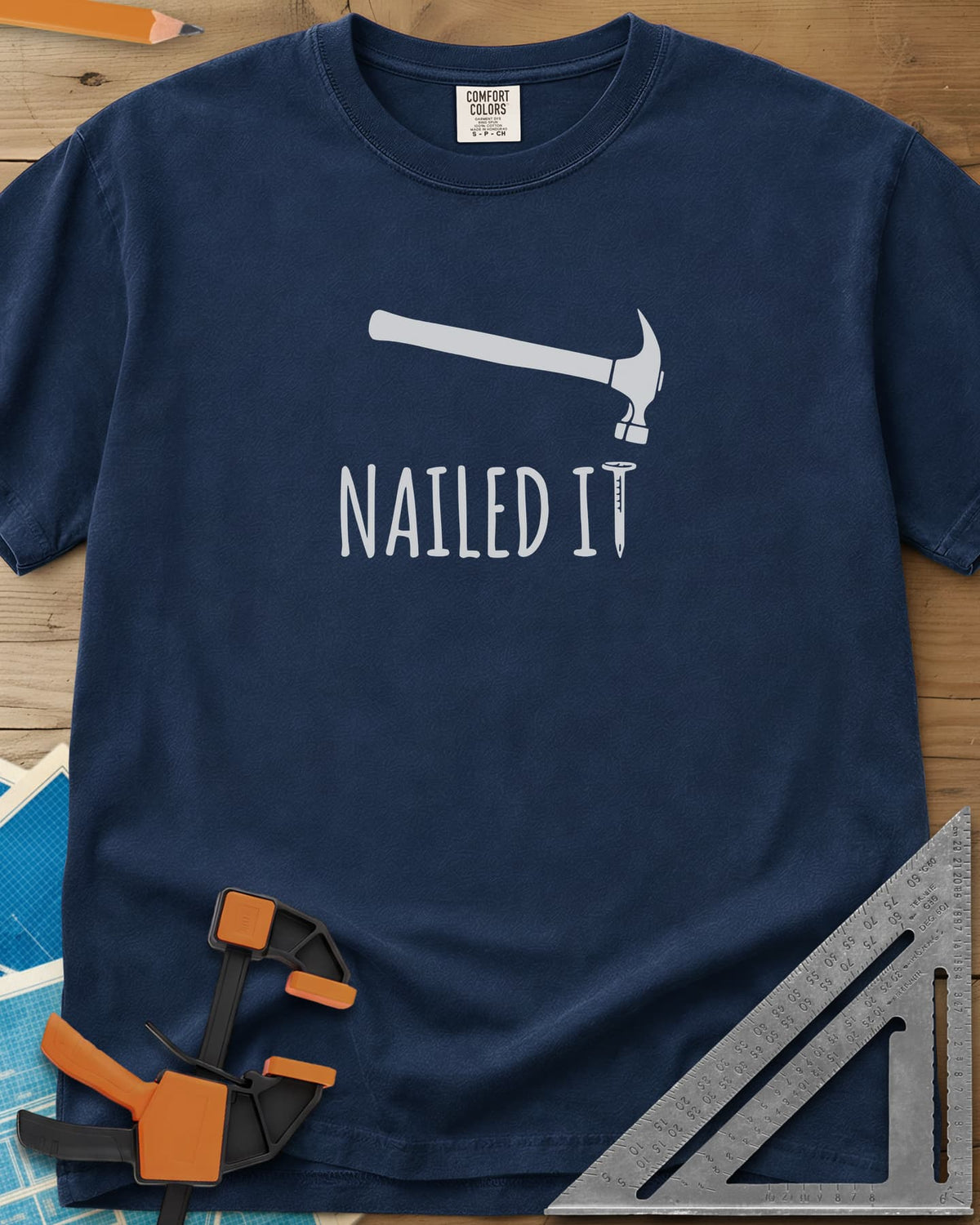 Nailed It heavyweight tee in Navy, a hammer over a nail that forms the T in IT