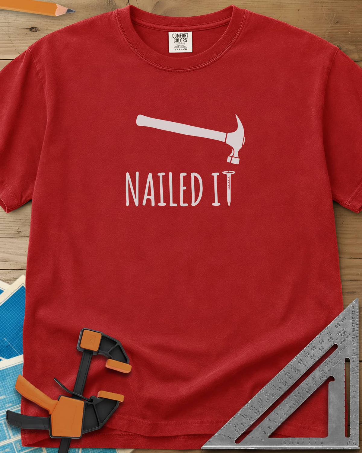 Nailed It heavyweight tee in Red, a hammer over a nail that forms the T in IT