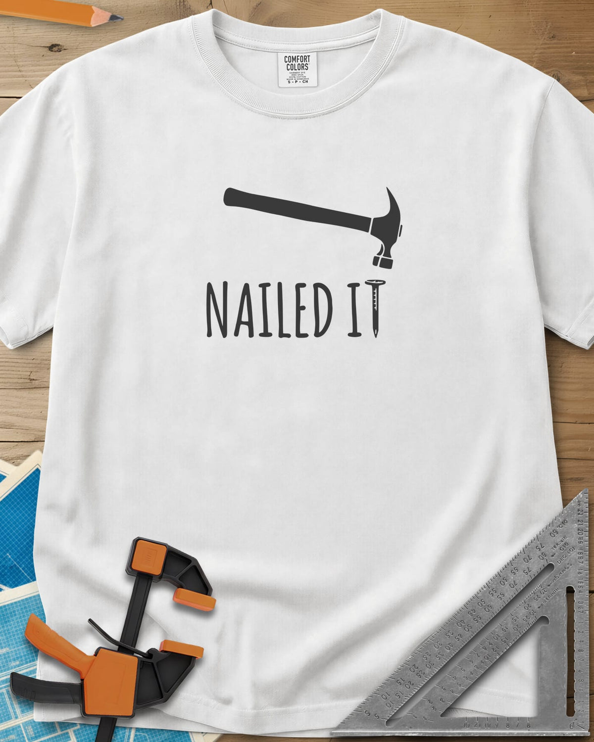 Nailed It heavyweight tee in White, a hammer over a nail that forms the T in IT
