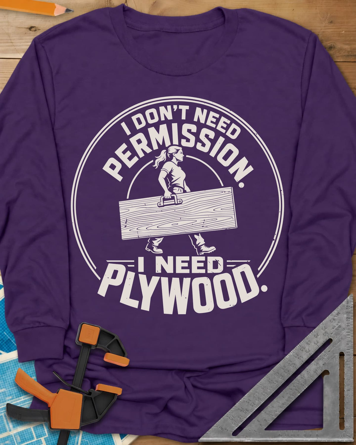 Need Plywood long sleeve shirt in Purple, a woman with a ponytail carrying a plywood sheet in a round badge