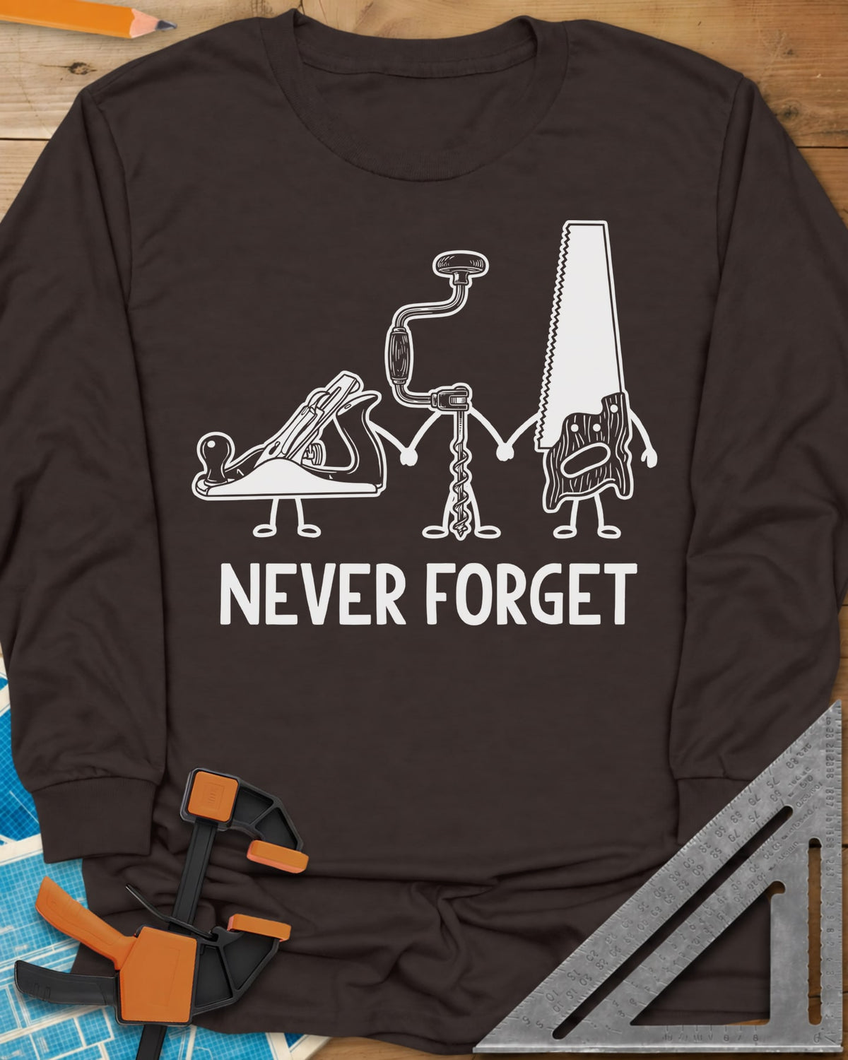 Never Forget long sleeve shirt in Dark Chocolate, three cartoon hand tools holding hands: a plane, a brace and a saw