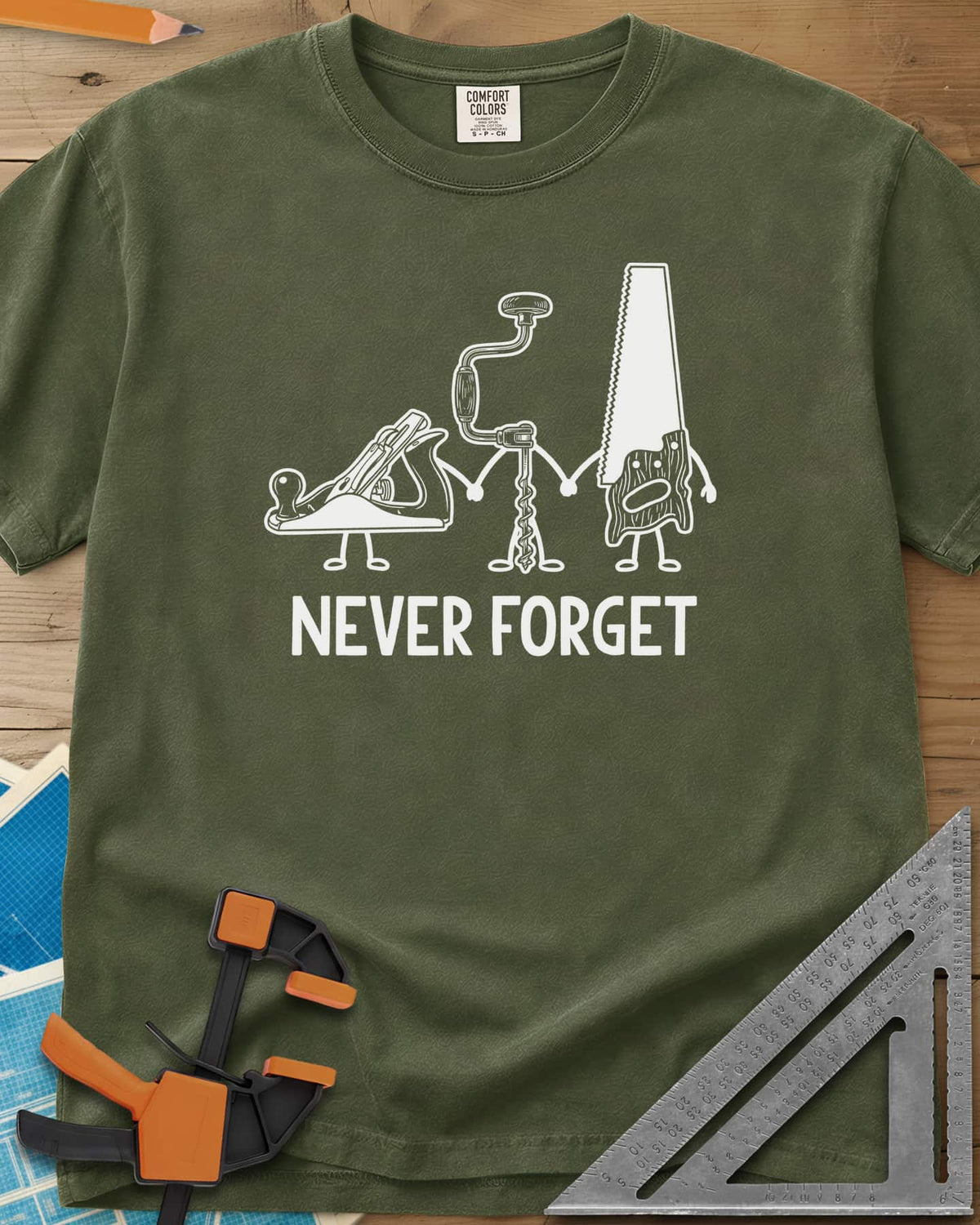 Never Forget heavyweight tee in Hemp, three cartoon hand tools holding hands: a plane, a brace and a saw