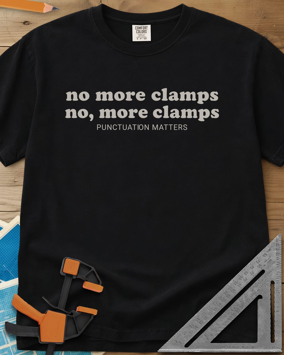 No More Clamps Punctuation Matters heavyweight tee in Black, two lowercase retro lines that differ by a comma, tagline below