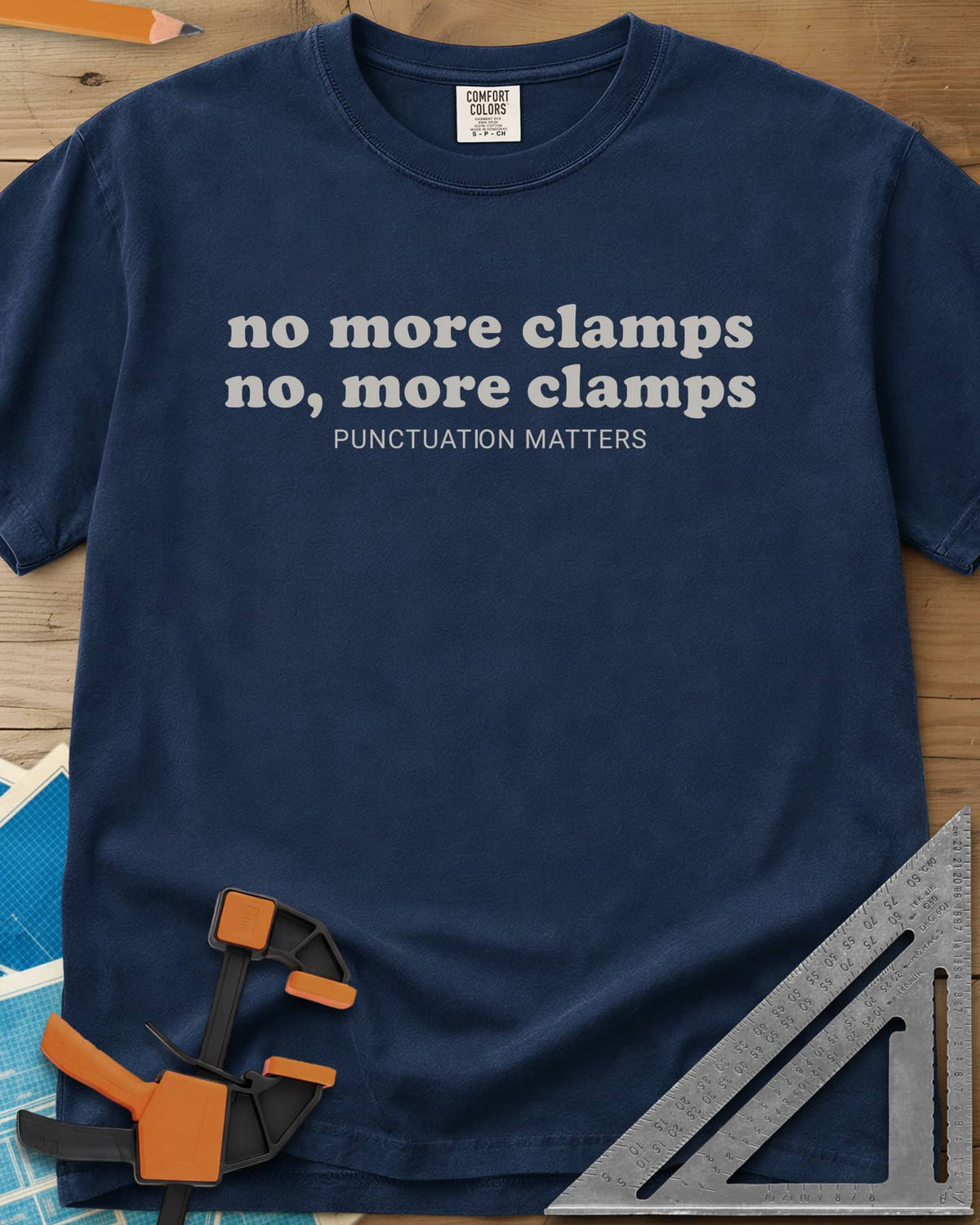 No More Clamps Punctuation Matters heavyweight tee in Navy, two lowercase retro lines that differ by a comma, tagline below